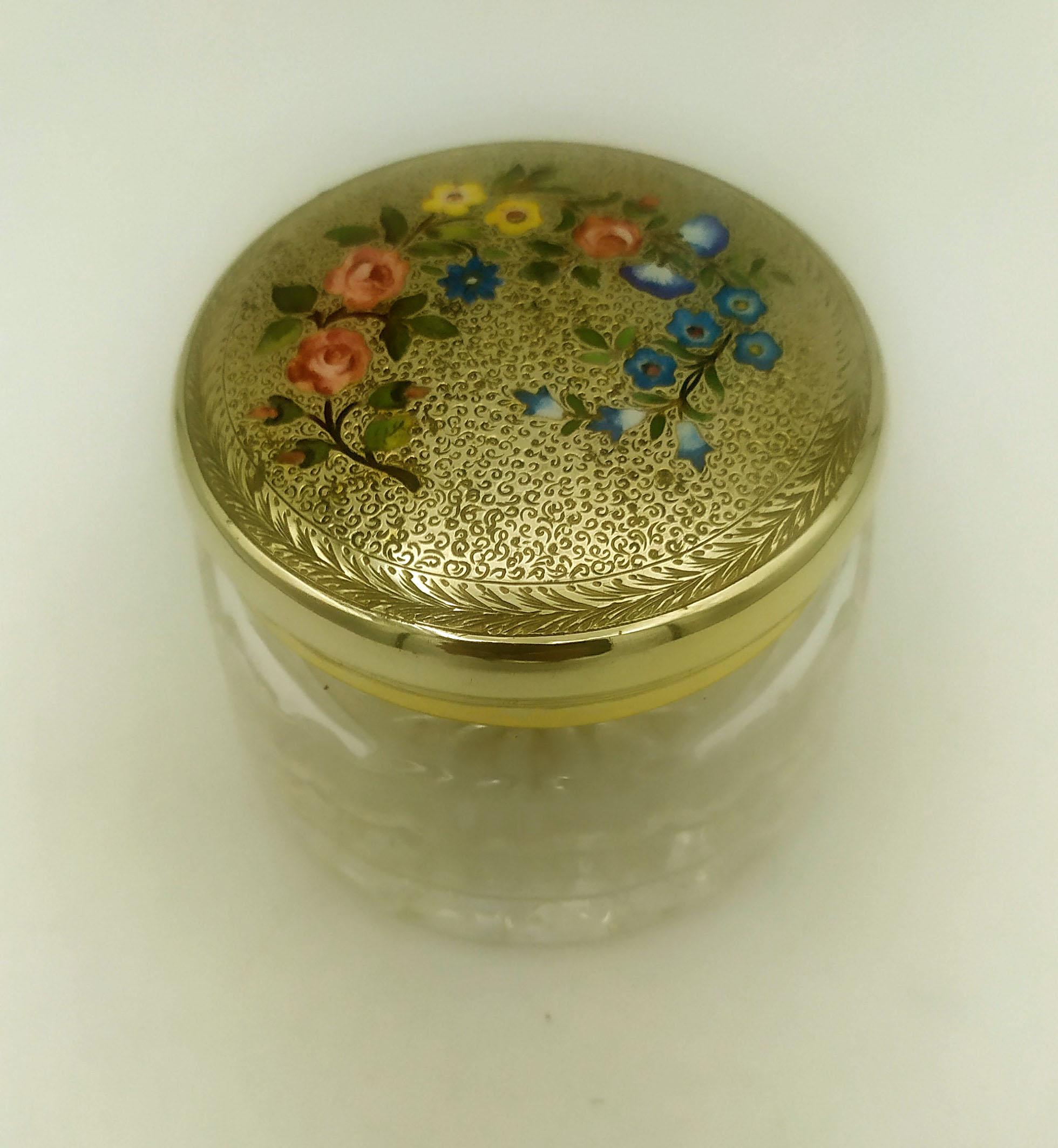 Round wedding favor with lid in 925/1000 sterling silver gold plated with fine manual engraving of flower shoots, fire-enamelled with various colours, in early 1900s Art Nouveau style and fine hand-engraved decoration around it. Vase below in cut