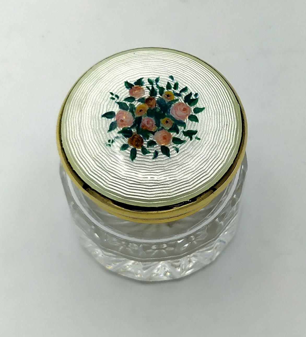 Wedding favor or small container in cut crystal and lid in 925/1000 sterling silver gold plated with translucent fired enamel on guillochè and hand painted floral miniature. Diameter cm. 4.2 total height cm. 4.5. Silver weight gr. 23.
Designed by