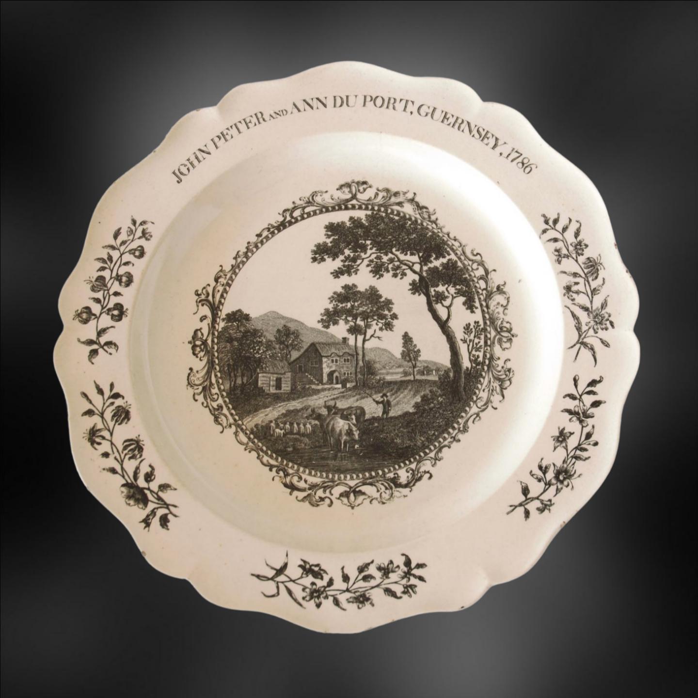 A creamware plate, with transfer printed decoration. From a service probably ordered to commemorate the wedding of John Peter and Ann Du Port, of Guernsey.

The plate is of plain creamware in the Royal Shape, later called Bewick. It is decorated
