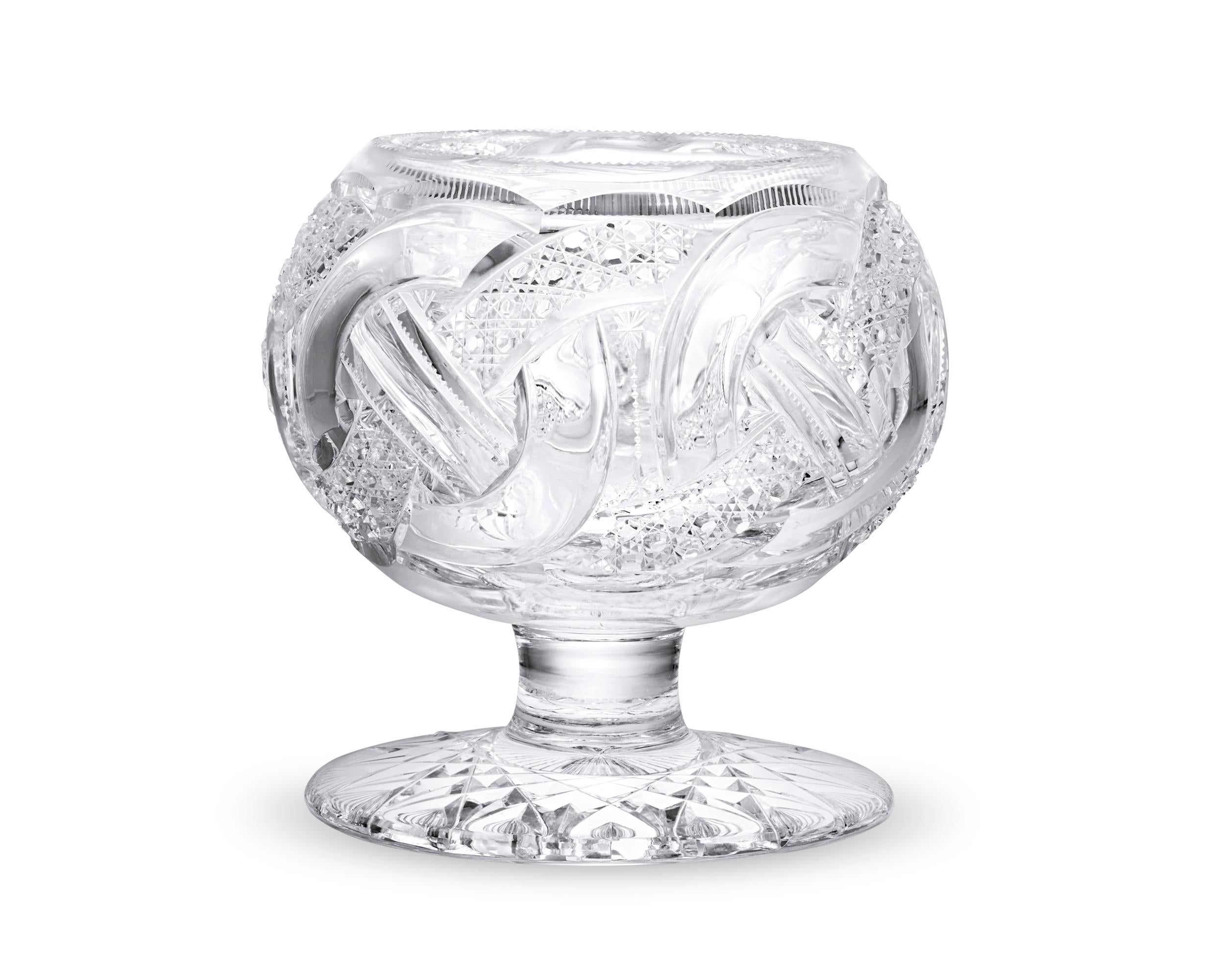 This incredibly rare footed rose bowl by J. Hoare & Co. is hand-crafted in the highly sought-after Wedding Ring pattern. This coveted American Brilliant Period cut glass pattern is characterized by a swirling motif of conjoined rings, executed with