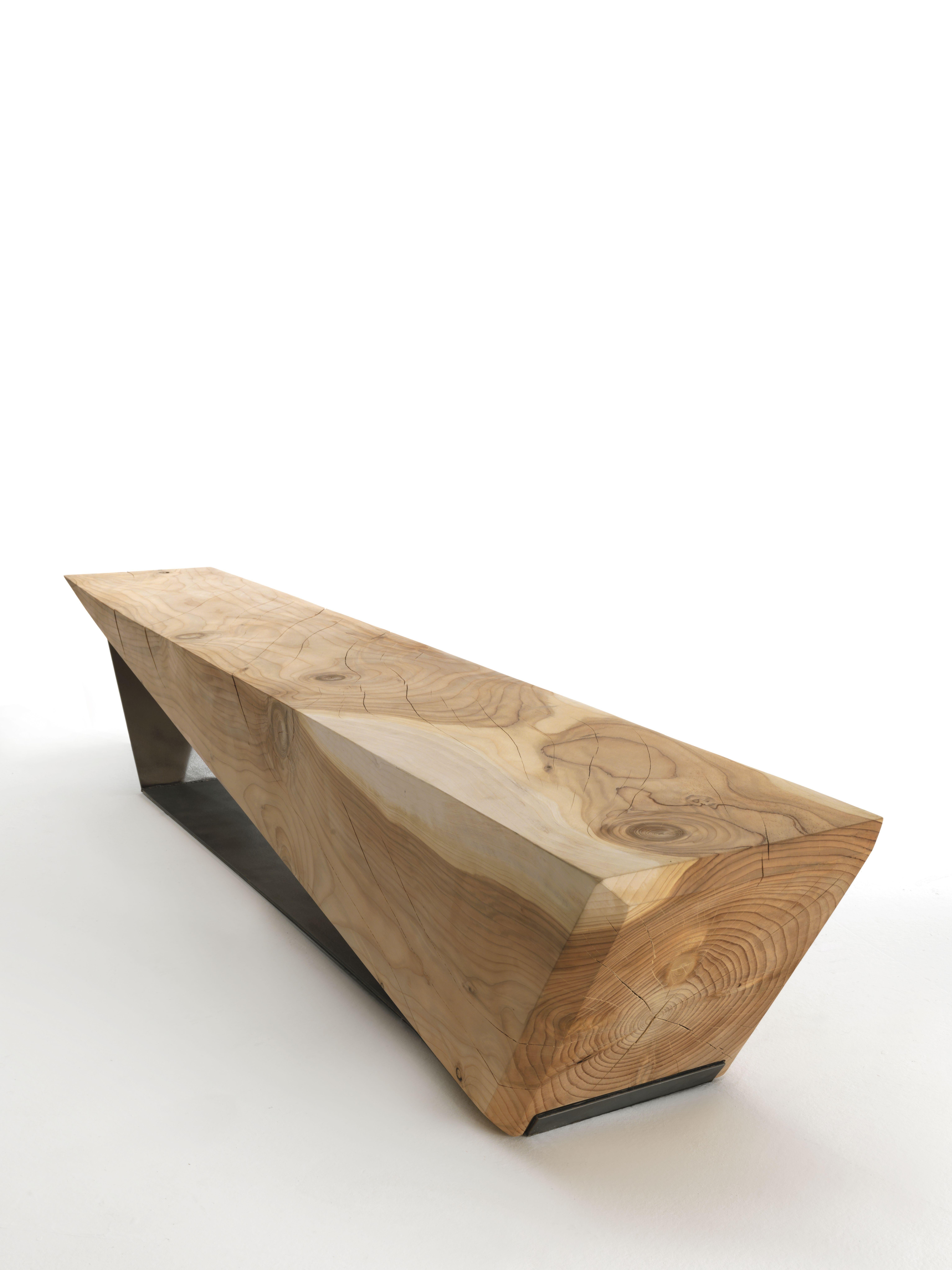 Bench made of a single block of scented cedar with a simple and linear geometrical shape that continues in the metallic base, which can be used as a container.