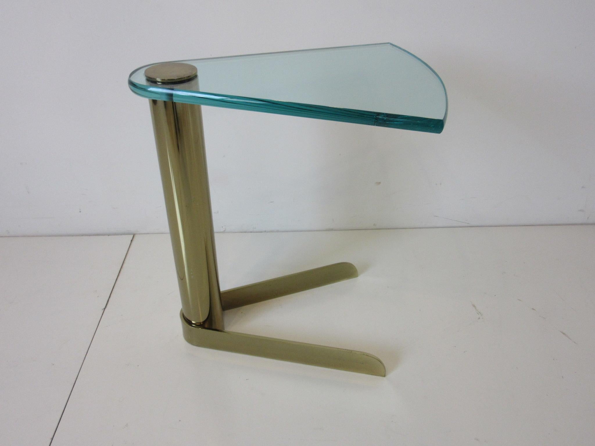A very well crafted, fine and rare brass and plate glass Wedge side or cocktail table designed by Leon Pace. This elegantly designed modern side table fits with a comfortable lounge or club chair having just the right size, glam and richness that