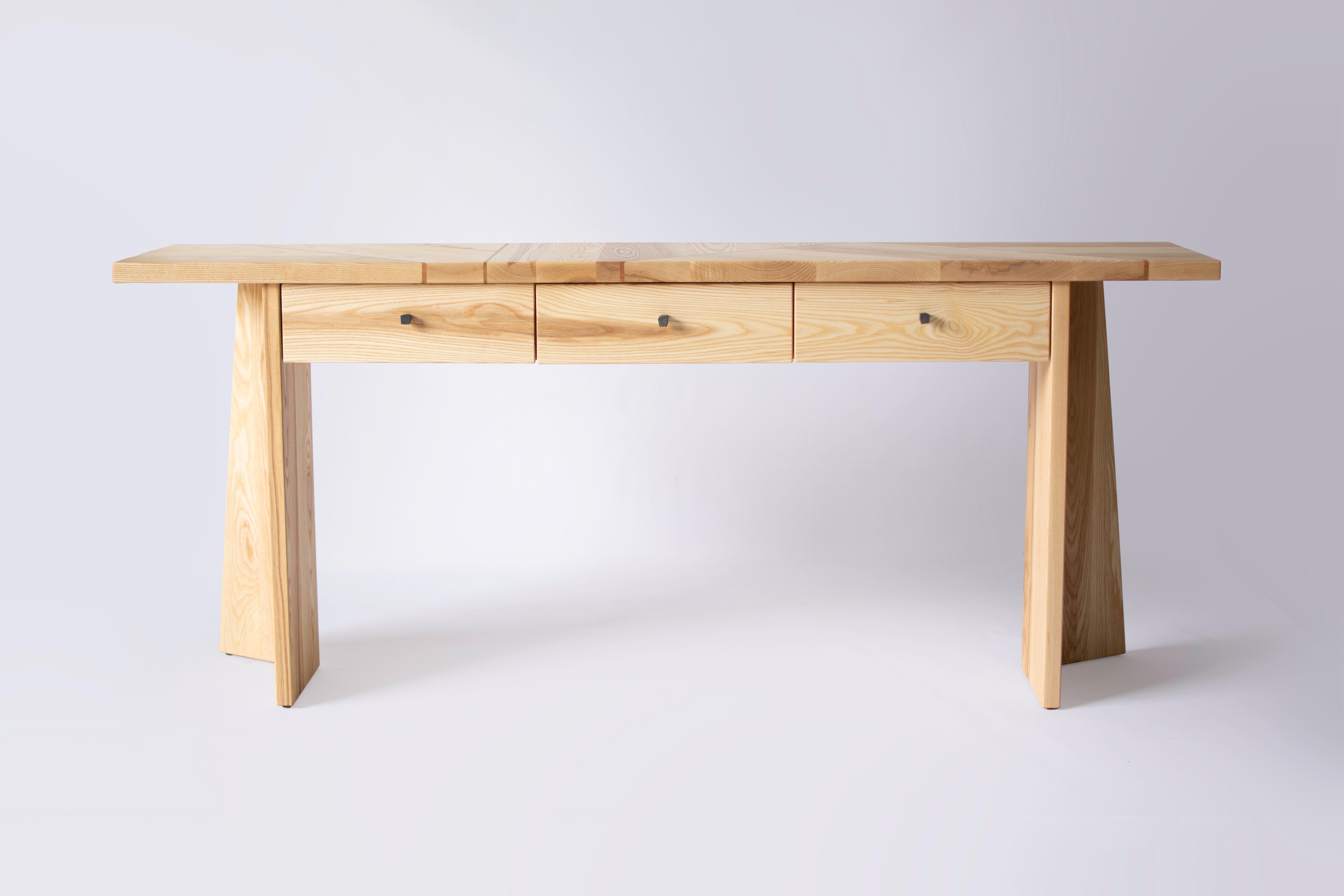 Angular slabs of solid ash are joined together with thin strips of cherry in order to form the butcher block style top for the Wedge table. The three small drawers are perfect for storing utensils and bar paraphernalia, while the open design of the
