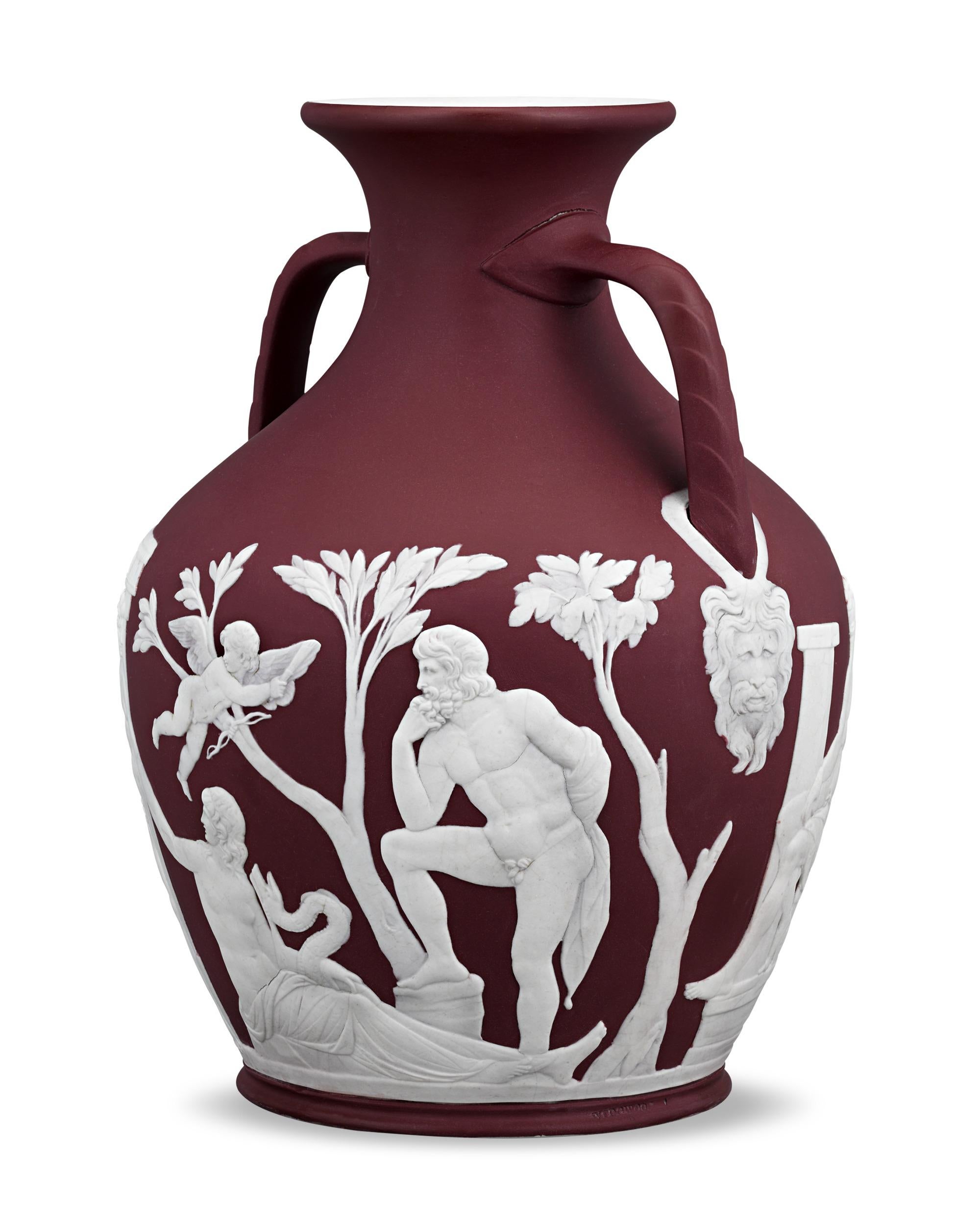 This remarkably rare Portland Vase by Wedgwood boasts a highly coveted crimson hue. As the vivid red coloring was difficult to control and prone to bleeding, crimson dip jasperware was only produced by the manufactory for a brief period, making it