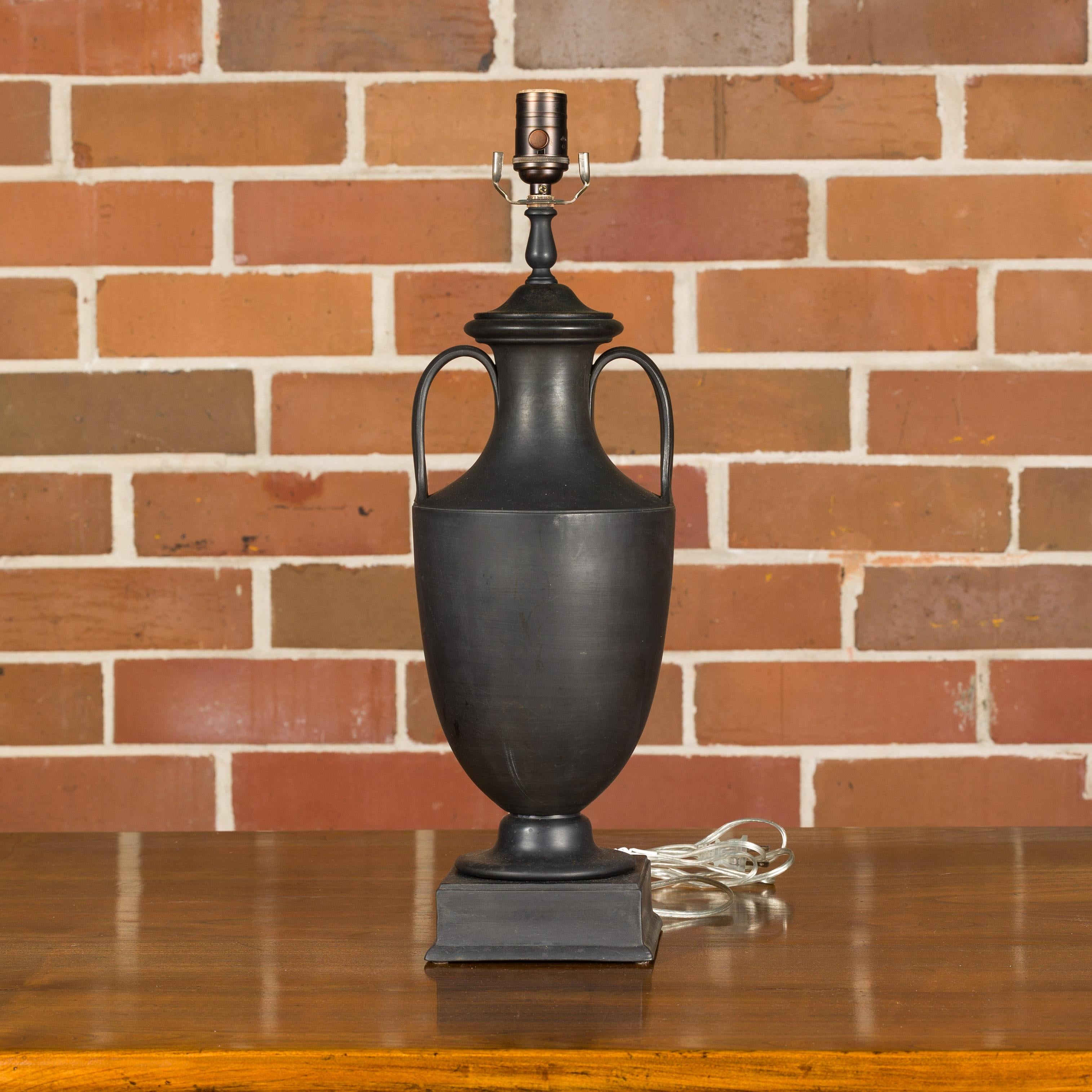 A Wedgwood basalt amphora from the 19th century made into a single socket table lamp, wired for the USA. This exquisite 19th-century Wedgwood basalt amphora has been masterfully transformed into a sophisticated single socket table lamp, elegantly