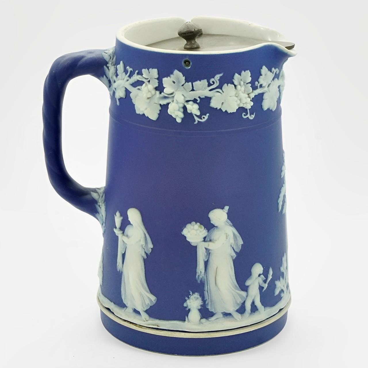 Beautiful Wedgwood antique Victorian dark cobalt blue jasperware Upright jug with a pewter lid. Featuring classical relief figures and a grapevine edging, and the handle has a rope twist design. Measuring height 11.7 cm / 4.5 inches, and the base is