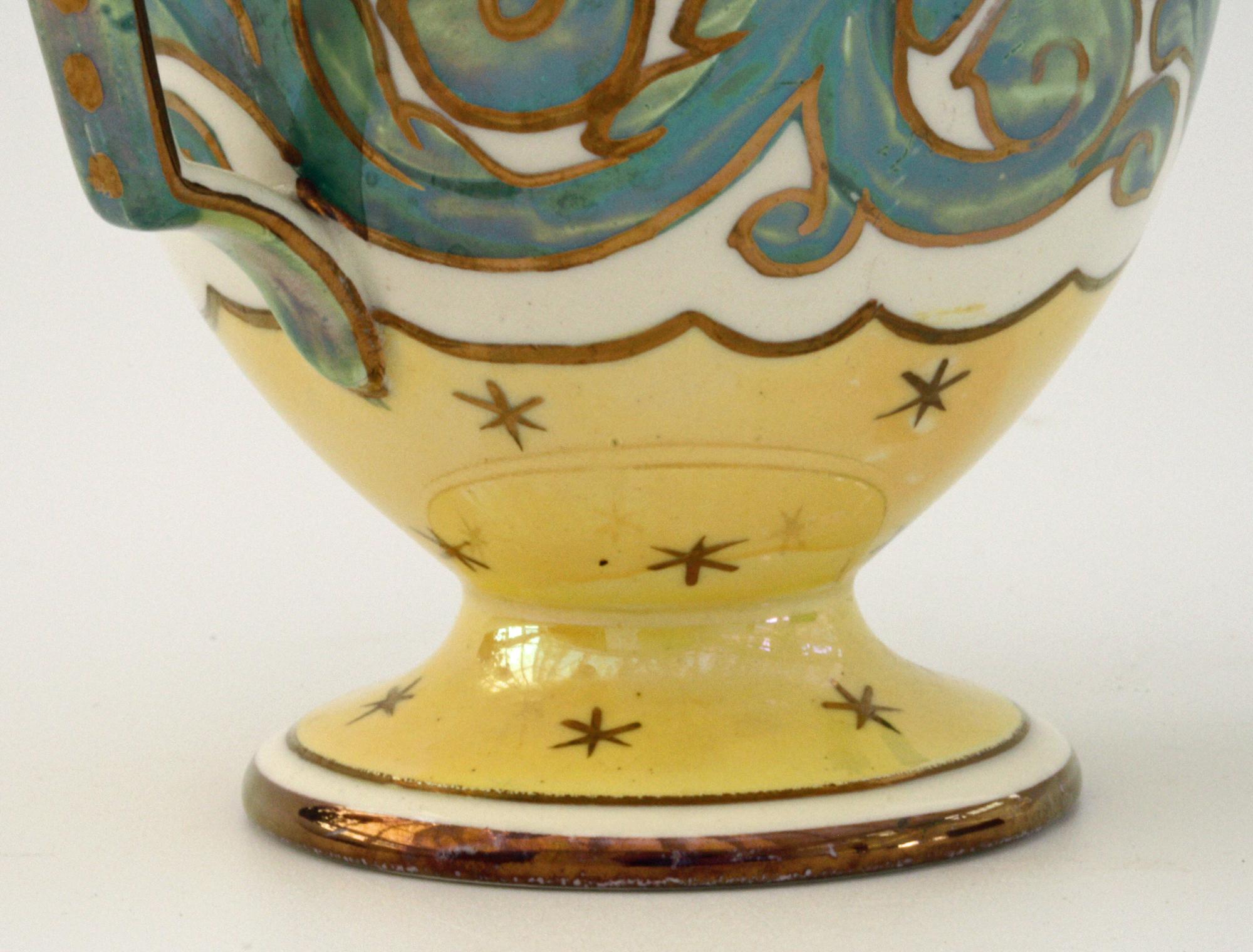 A stylish and unusual Art Nouveau Wedgwood lustre glazed twin handled pedestal cup believed to date from circa 1900. The cup stands raised on a rounded pedestal foot with loop handles applied to either side of the rounded cup shaped body. The cup is