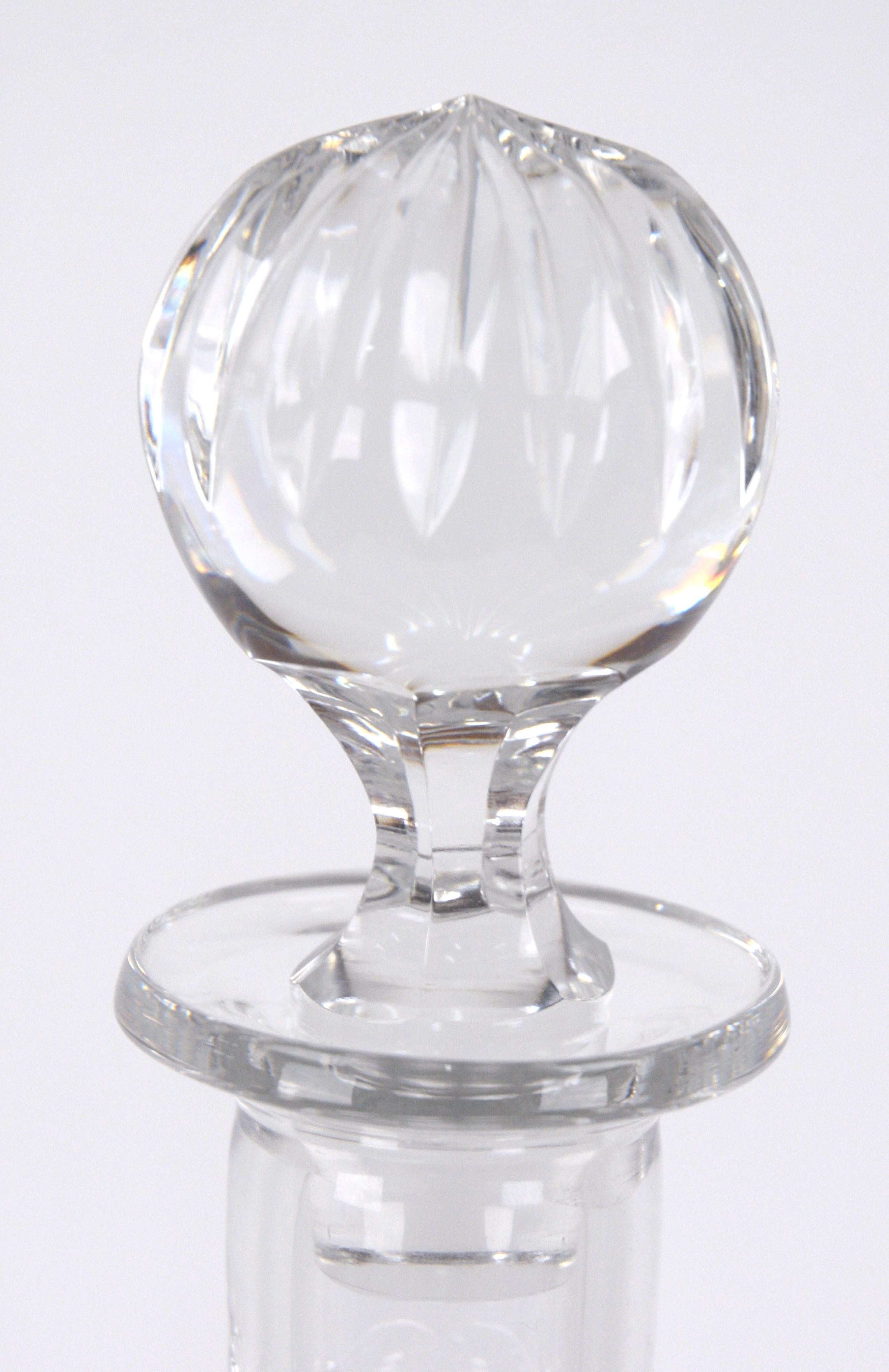 Elegant lead crystal decanter manufactured by Wedgwood, with original glass stopper. This piece has an elegant bulb shape with diamond-shaped facets cut into the sides. 