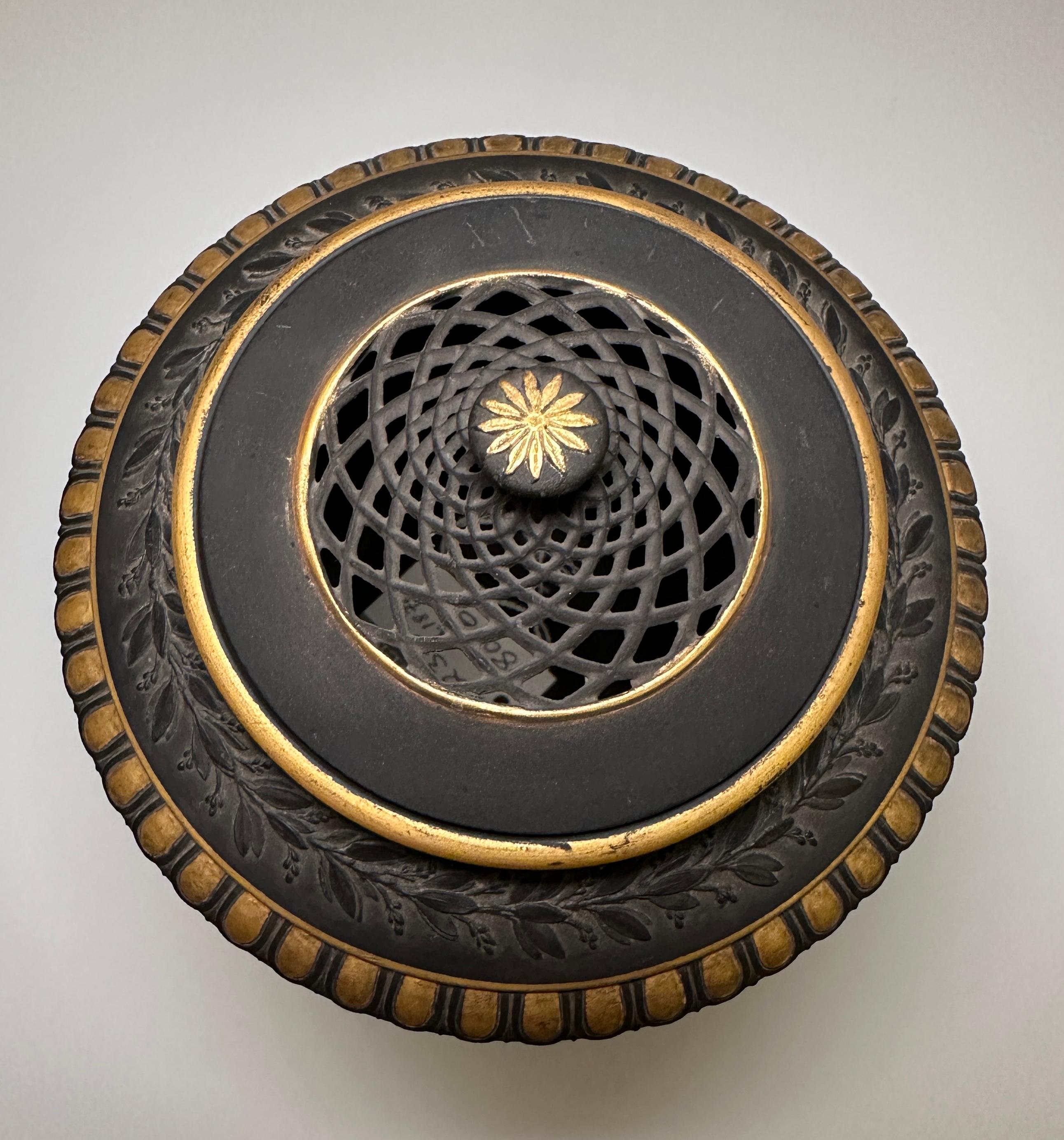 A wedgwood black and gilt basalt covered Potpourri vase, circa 1870.