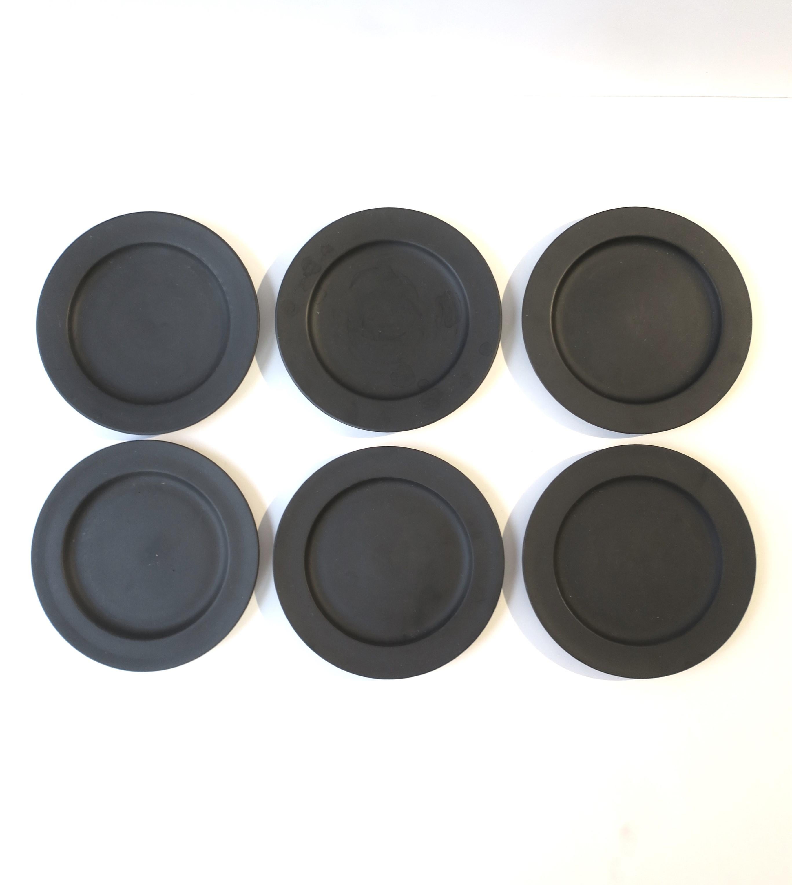 A beautiful set of six (6) English black basalt plates by Wedgwood, circa early to mid-20th century, England. Plates could be used a myriad of ways (appetizer plates, dessert, etc., or decorative on a wall.) With maker's mark on bottom of all six