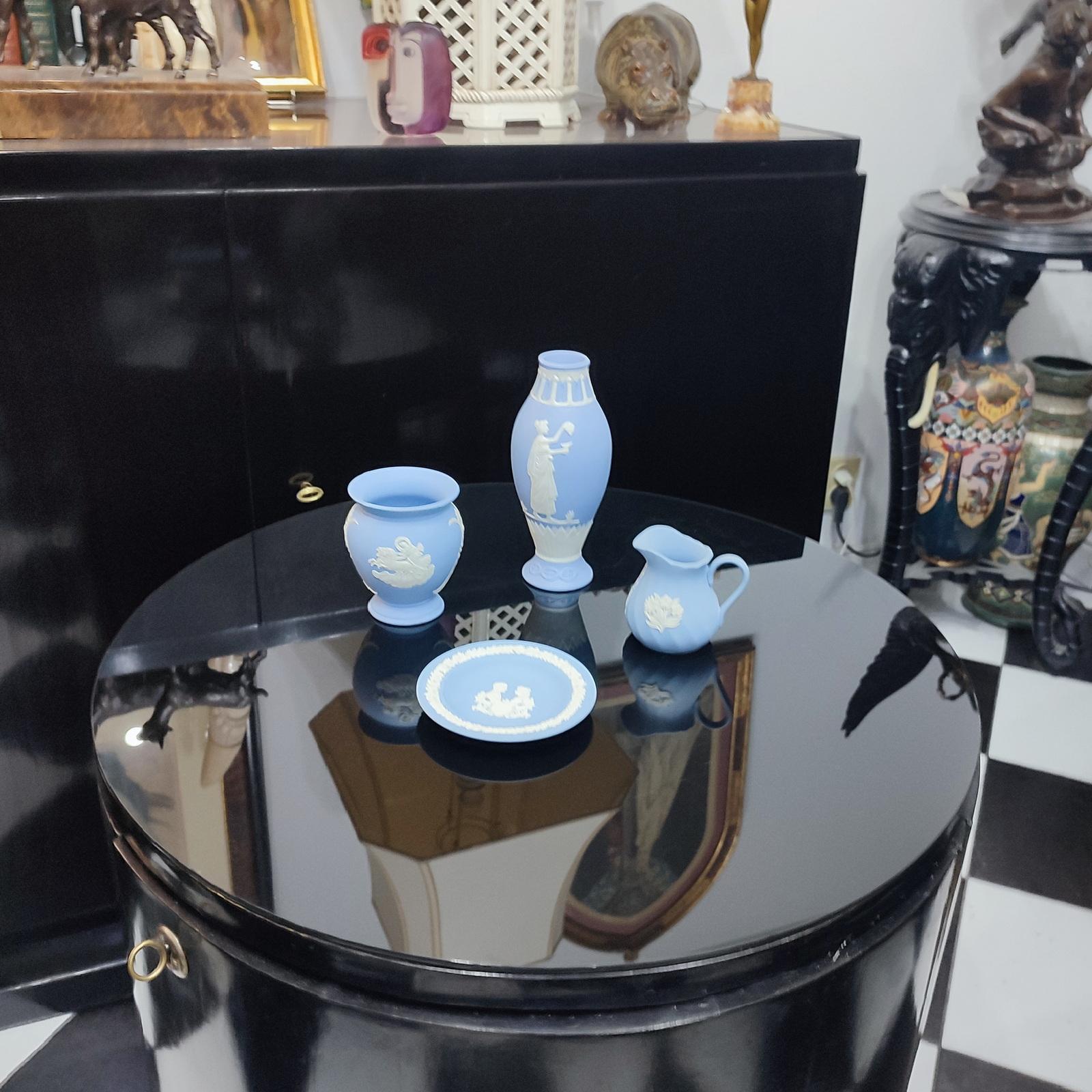 A lovely collection of Wedgwood Jasperware Pale Blue four pieces, comprising a large vase, a short one, a mall pitcher (milk) and a small round tray. Made by Wedgwood in England in 1980s, marked/stamped on base.

Enter code FREESHIP at checkout to