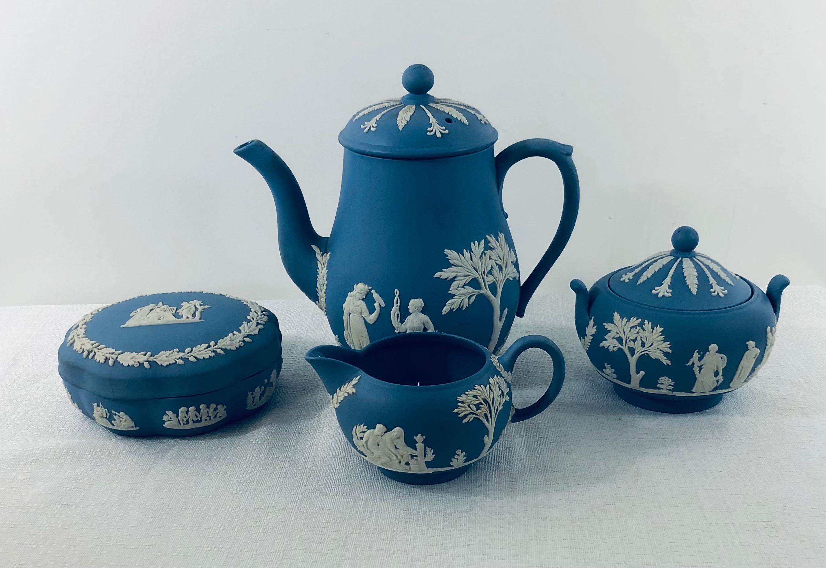 A set of 5 English Wedgwood Jasperware decorative tea serving pieces in “Wedgwood Blue”.
The set is composed of tea pot, a creamer, bombonier and sugar bowl. Each piece features a white design depicting high relief acanthus leaves and white