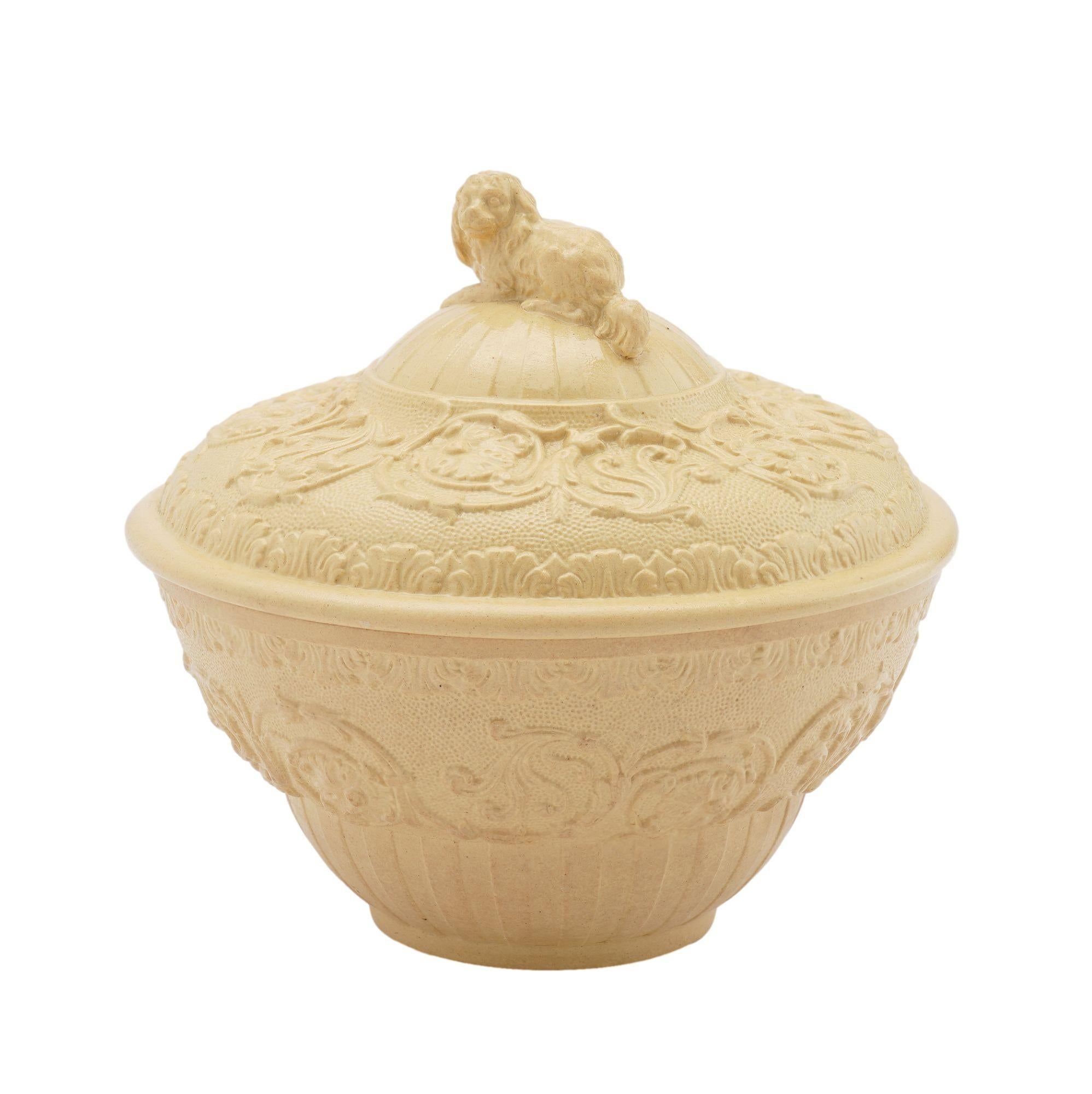 Caneware ceramic sugar bowl with cover and raised pattern surface decoration and a King Charles spaniel finial on the cover.
Stamped on the underside: Wedgwood

England, circa 1815-20.