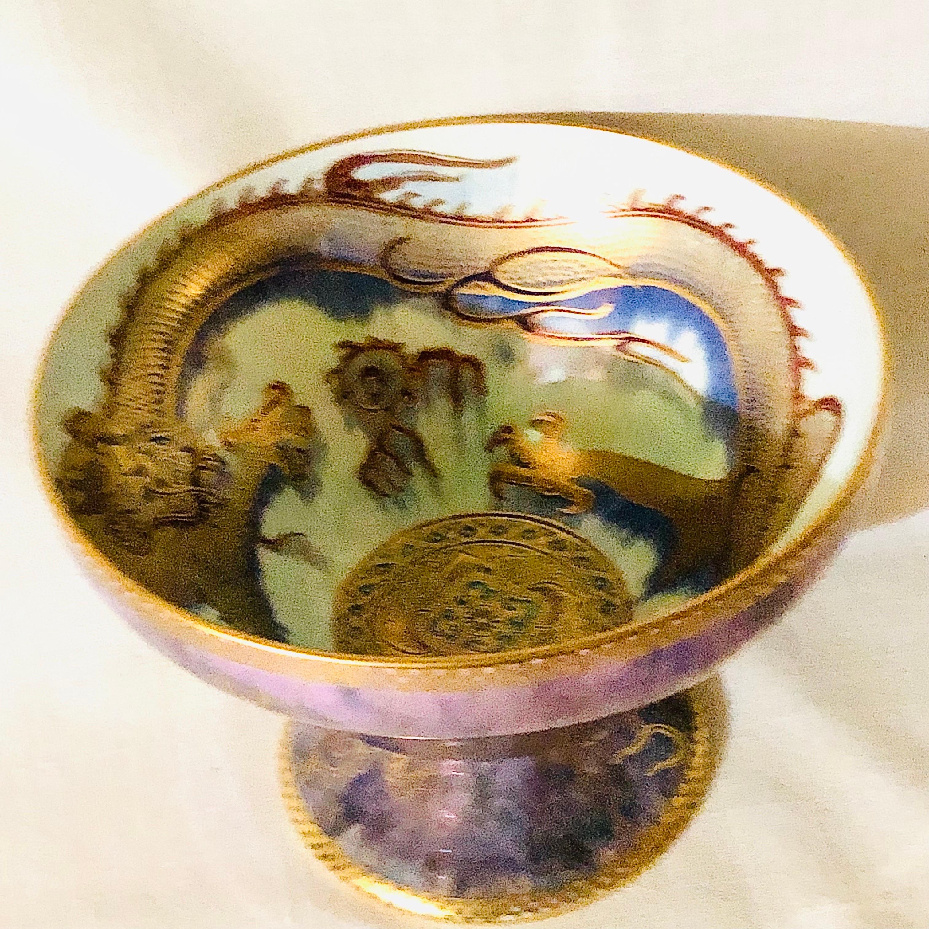 This is a fabulous Wedgwood celestial dragons fairyland luster bowl. These celestial dragon bowls were decorated by Daisy Makeig-Jones. This striking bowl is decorated with gold dragons on a purple luster base on the outside of the bowl. The inside