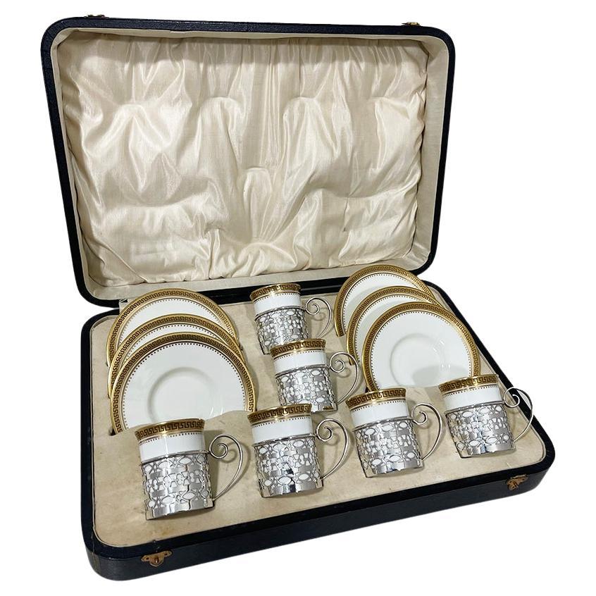 Wedgwood coffee cups and saucers with silver cup holders by Walker & Hall, 1919