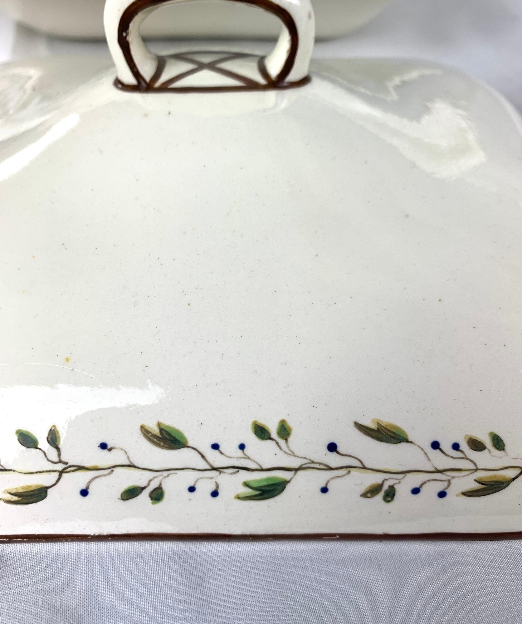 The set was hand painted at Wedgwood, in England, circa 1785.
The borders are decorated with a delicate band of green leaves and berries on the vine, and the edges are painted brown.
The pattern is typical of the patterns found in the Wedgwood