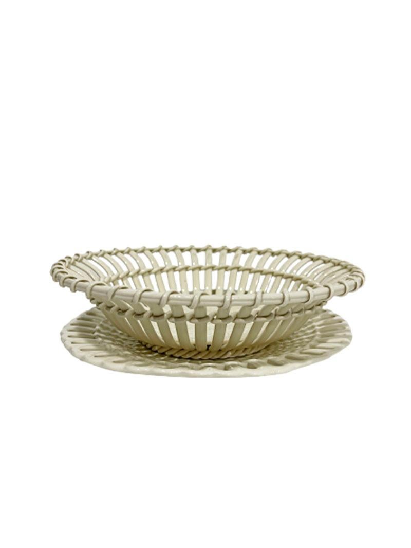 Wedgwood creamware open weave basket with plate, 1924-1930

A Wedgwood England creamware round form, with open weave basket pattern with under plate
Dated and marked by Wedgwood, made in England 1924-1930
The creamware shows some crackle and