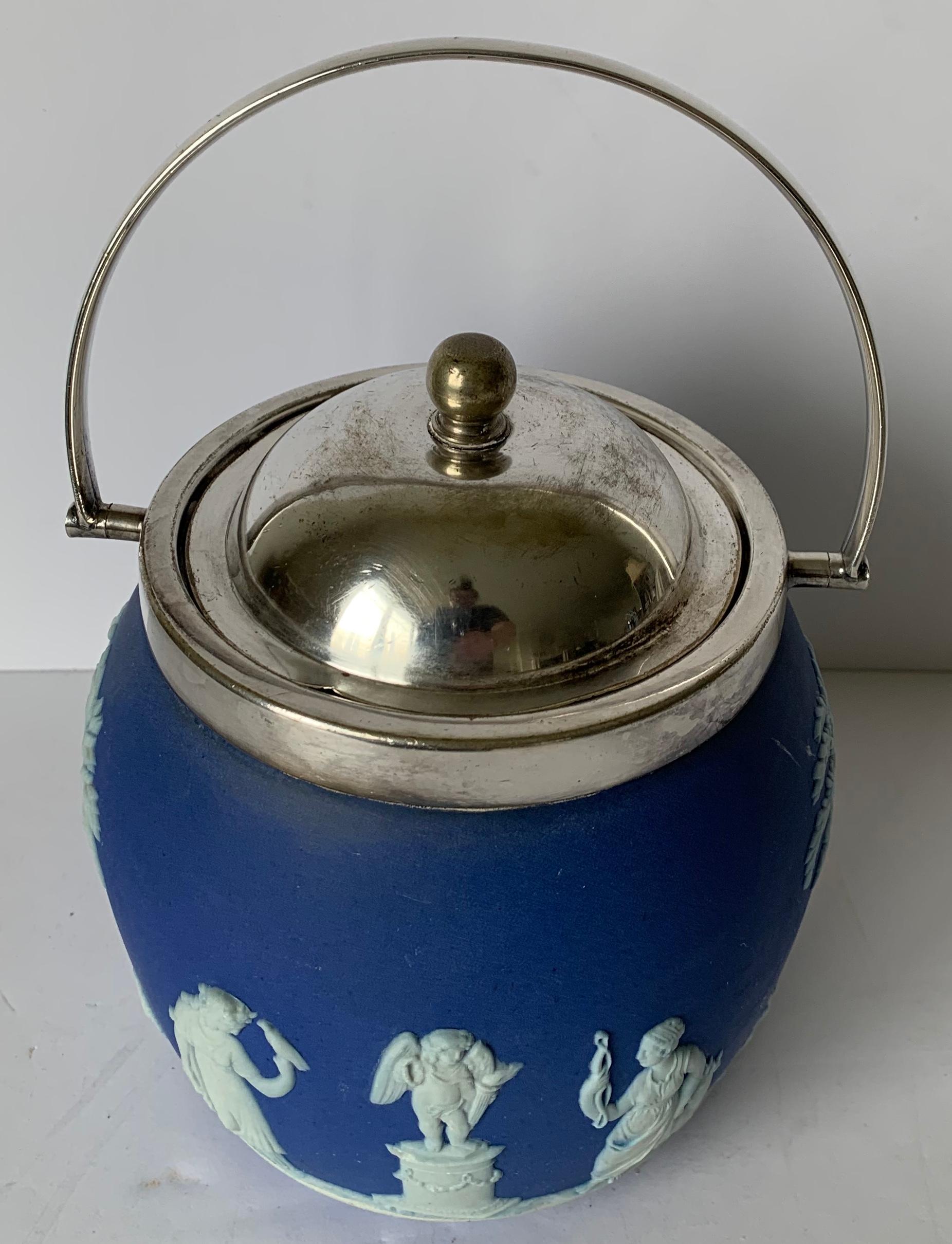 Wedgwood dark blue jasperware biscuit barrel overall neoclassical motif with a silver plated lid and handle. Stamped Wedgwood on the underside and lid is marked.