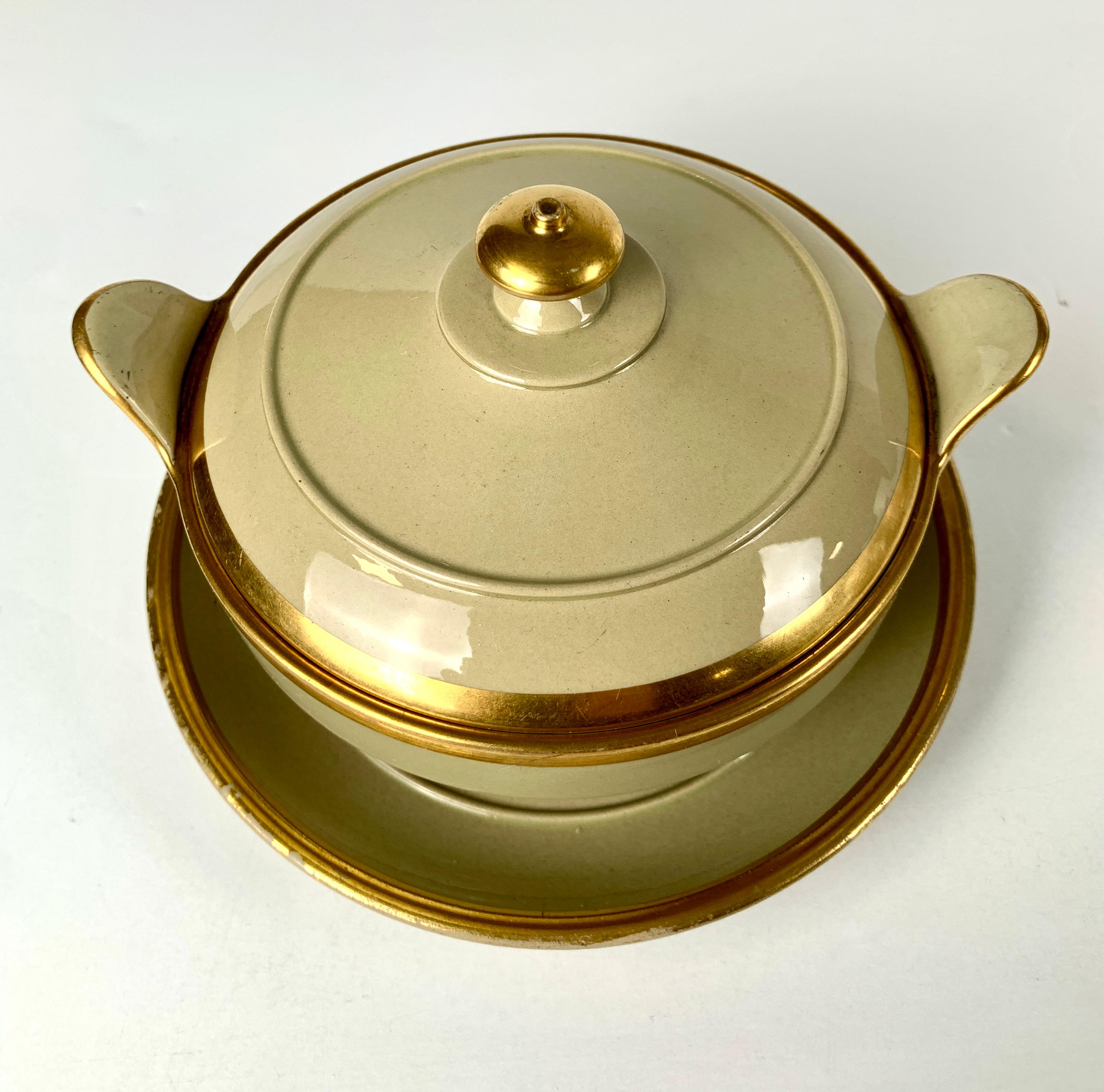 Wedgwood made this drabware sugar bowl and stand in Staffordshire, England, in the first quarter of the 19th century, circa 1825.
The design is simple and elegant, and the decoration is minimal, with only a bit of gilt trim accentuating the shape