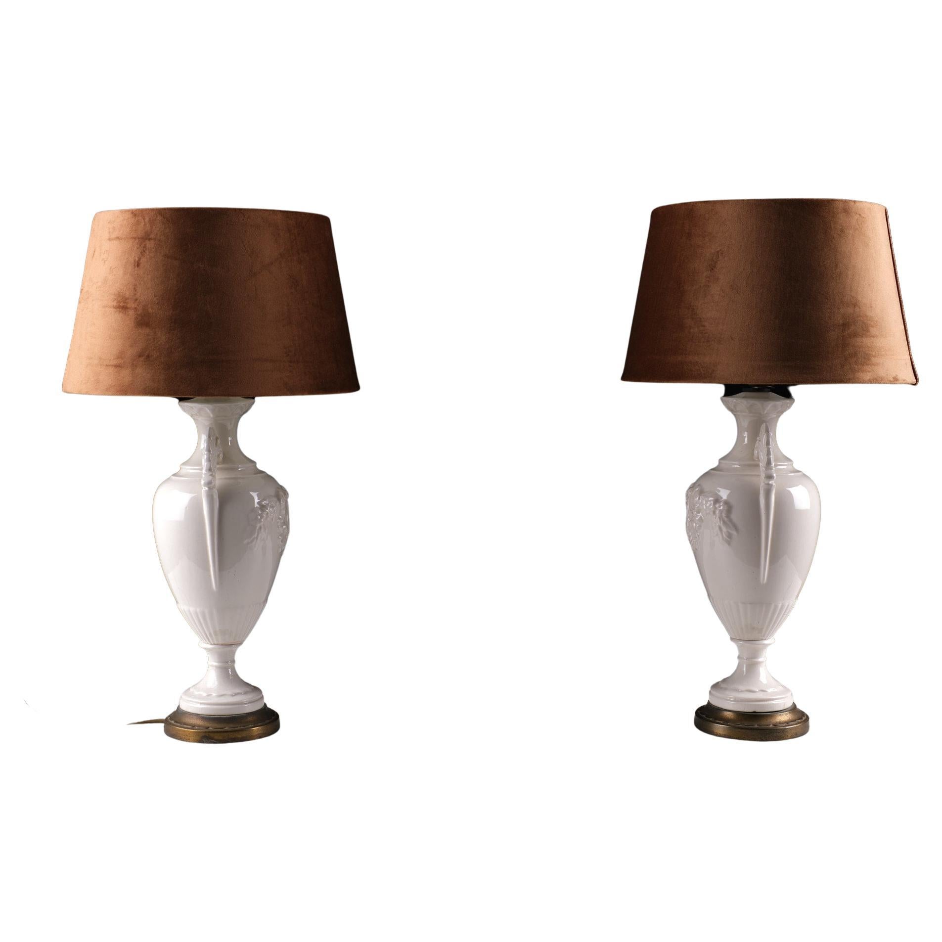 Two beautiful creme ware table lamps. Attribute to Wedgwood.
Classic Greek shaped model, embossed with a medallion in the middle, comes complete with new brown velvet shades .one large E27 bulb needed.
 Very good condition.
 