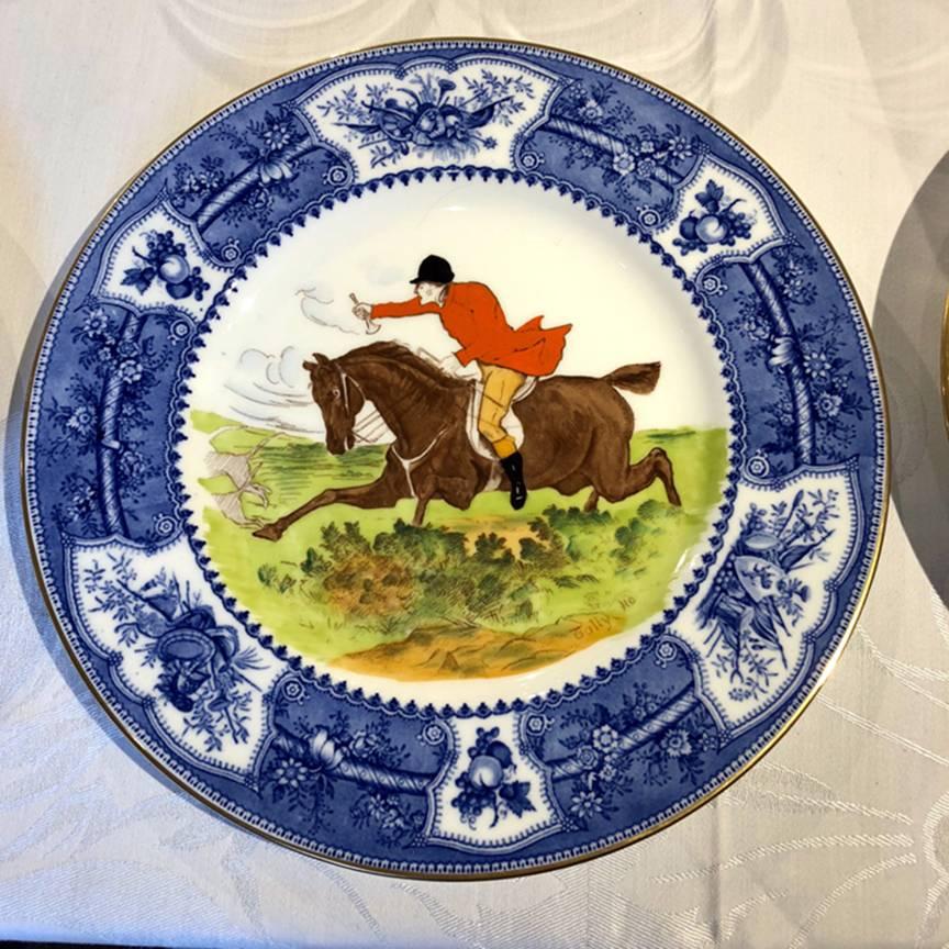 Wonderful set of hand-colored hunt plates with named scenes, realistically painted yet whimsical. Beautifully framed by blue and white borders. Six different scenes for either a cabinet or impressive service plates.