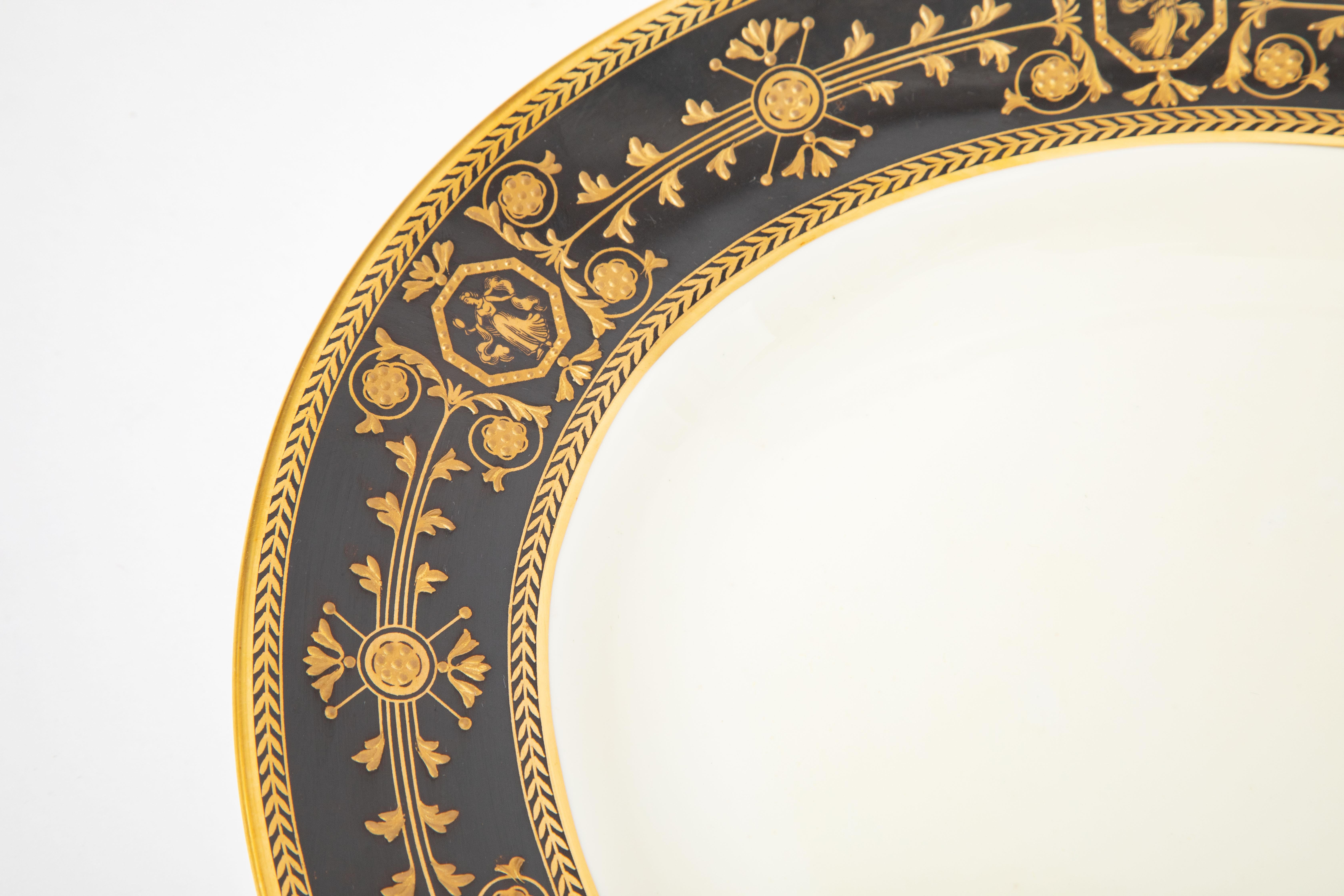 One of Wedgwood's signature patterns, Astbury with a Greco classic raised tooled gilding design on the striking black collar. The platter is nice and large and will be very versatile for entertaining. We love the crisp white porcelain ground and it