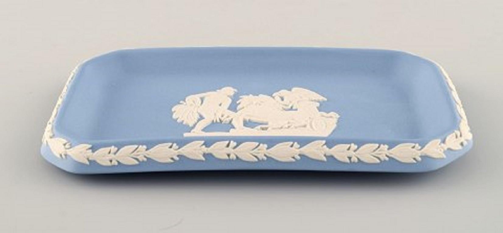 Wedgwood, England. Small square dish in light blue stoneware with classicist scenes in white, circa 1930.
Measures: 16 x 8.5 cm.
Stamped.
In very good condition.