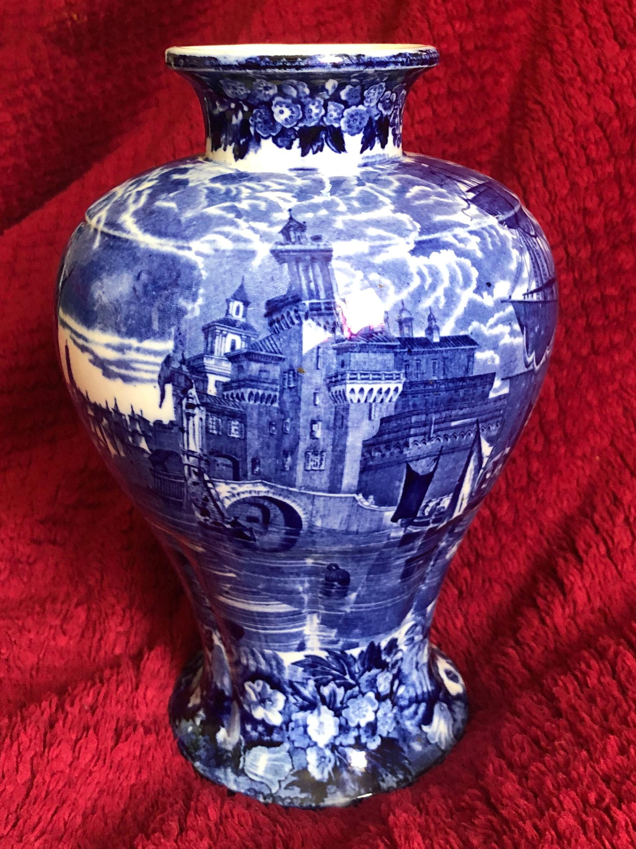 A fine Wedgwood Etruria lidded blue and white lidded vase in baluster form with a short neck. It is the famous sought after Ferrara pattern and depicts lively scenes of people sailing on a canal, ships and beautiful ancient buildings. A floral