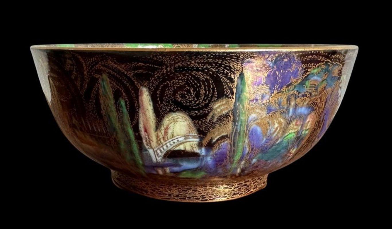 171
Wedgwood Fairyland Lustre Circular Bowl decorated with the “Poplar Trees” and “Fairy in a Hat” designs by Daisy Makeig Jones.
circa 1920.
Measures: 25cm wide, 11cm high.