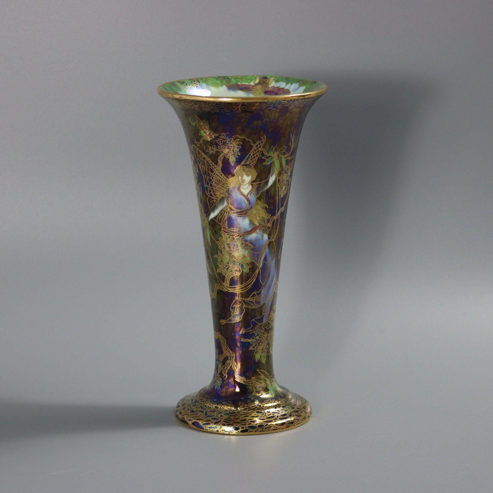 Wedgwood Fairyland Lustre trumpet vase decorated in the Butterfly Women pattern. This pattern features winged and robed female figures, perched in a blossoming tree. The interior of the vase has various imps riding on the backs of birds and