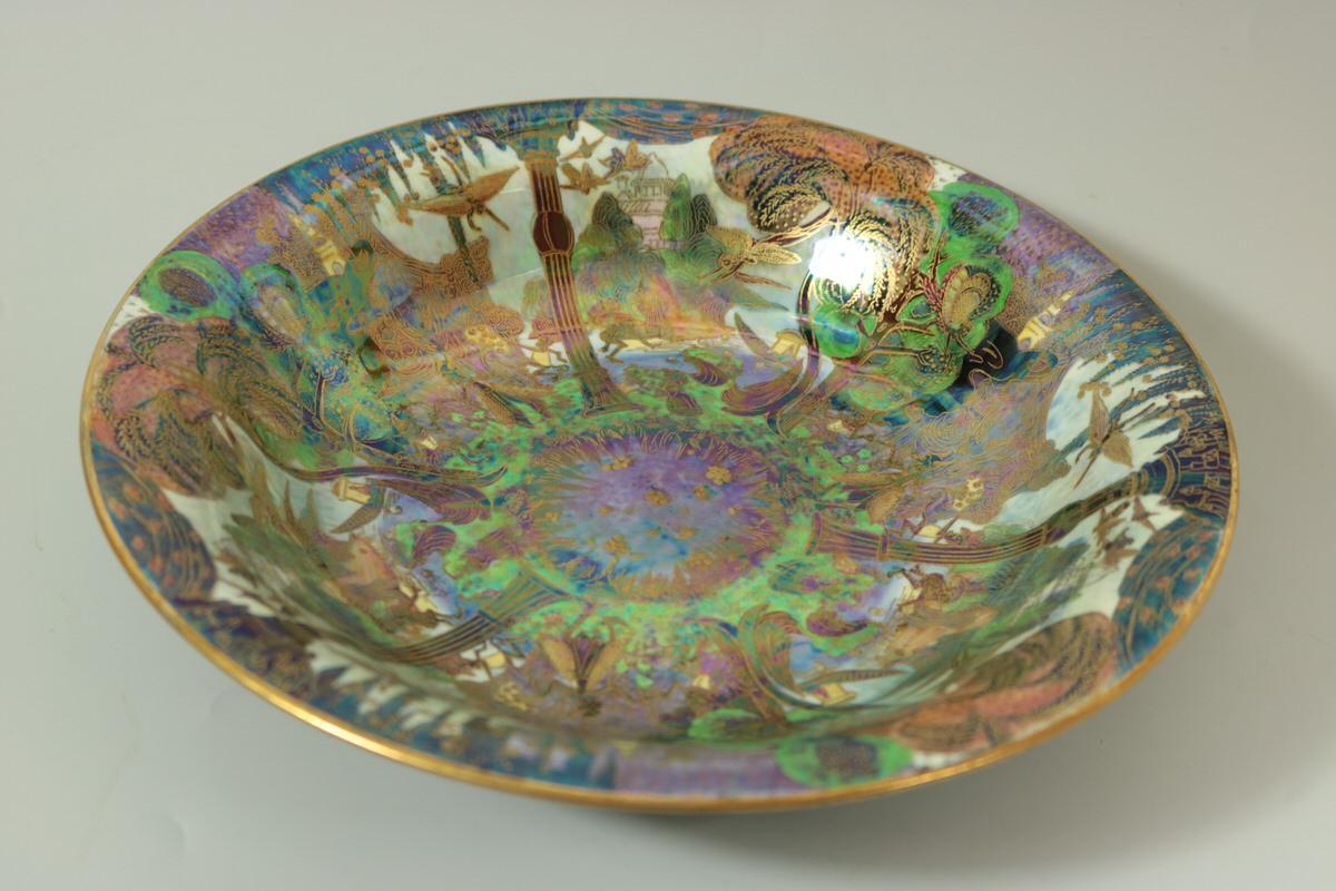 Wedgwood Fairyland Lustre Lily Tray, shape number 2483. Decorated with 'Garden of Paradise' pattern to interior, 'Flight of Birds' to exterior. 'Pebble and Grass' border to exterior rim and foot rim. Maker's marks painted pattern number Z4968.