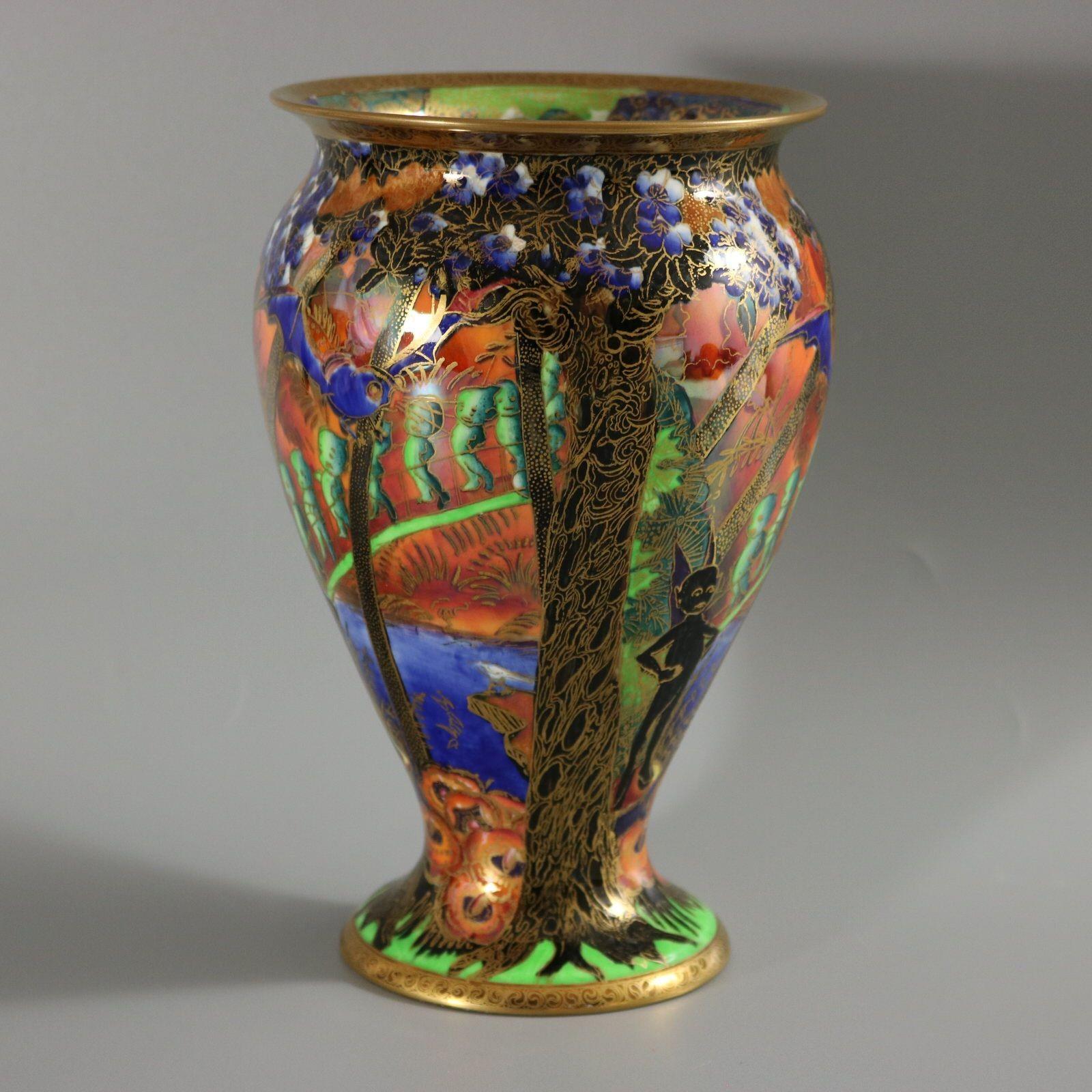 Wedgwood Fairyland Lustre vase decorated in the Imps on a bridge pattern. This pattern features a line of imps crossing a bridge. A bird sits on the shoreline of a lake below the bridge. Above the bridge is a Roc bird in flight. A 'Bubble' boy