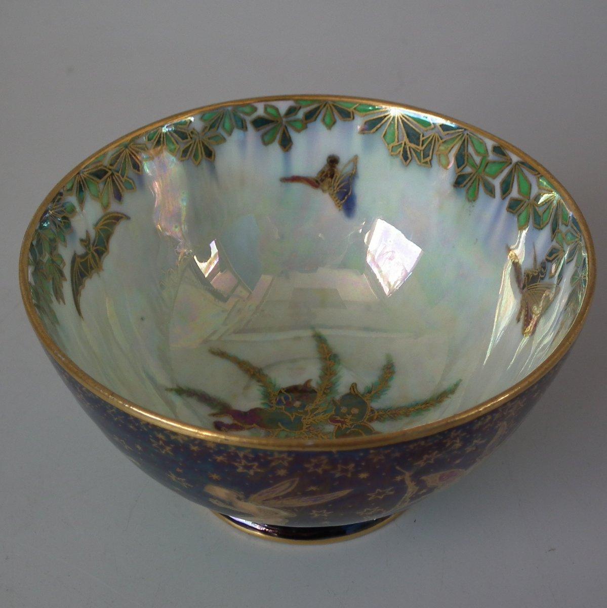 Wedgwood Fairyland Lustre York cup. Exterior decorated with 'Leapfrogging Elves' design on black ground. 'Elves on a Branch' design on mother of pearl ground to interior. 'Portland Vase' backstamp to the underside.