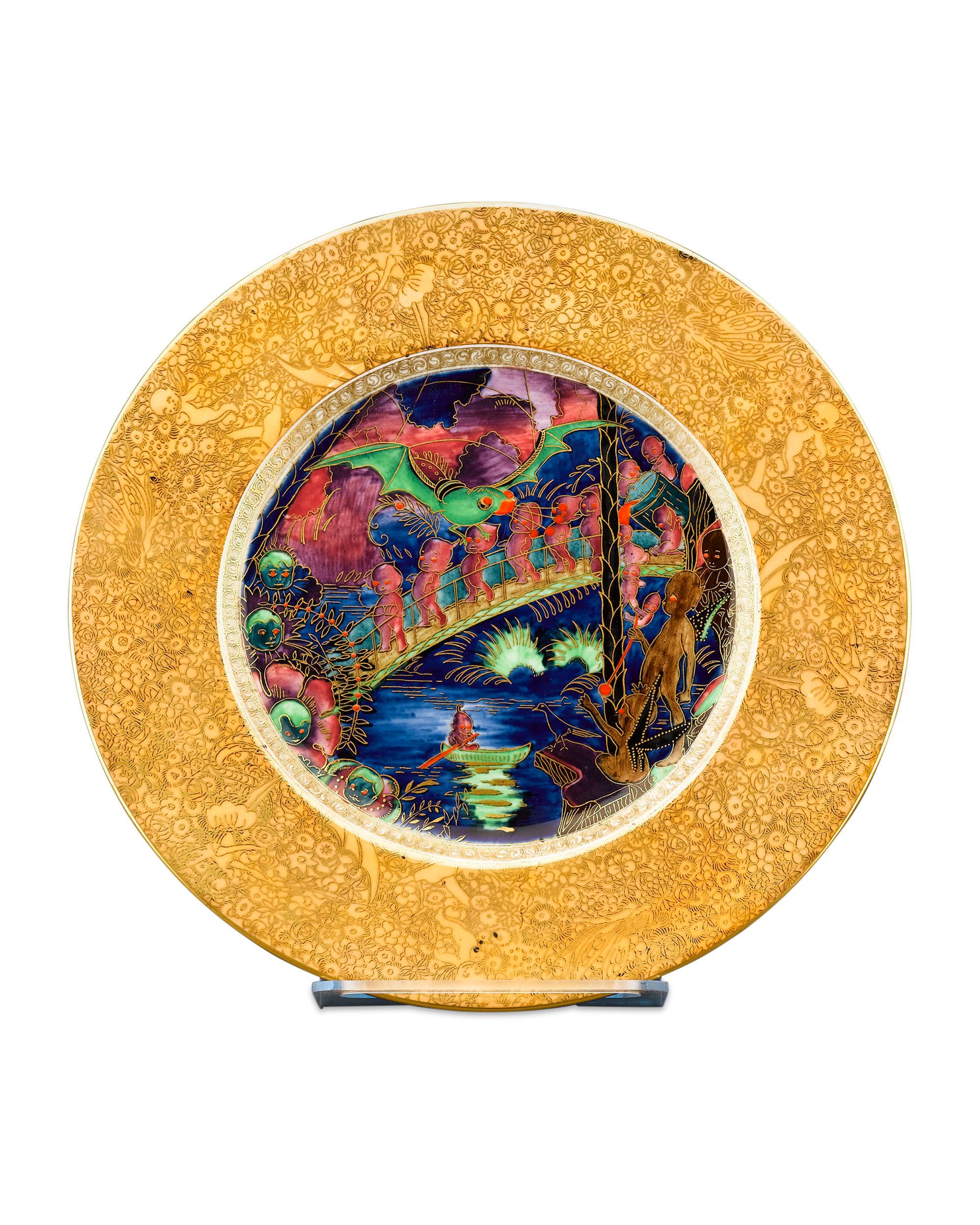 This enchanting Wedgwood Fairyland Lustre plate is decorated in a rare variation of the desirable Imps on a Bridge and Treehouse pattern. Called the Roc Centre variation, this magical scene is populated by maroon imps crossing a bridge with brown