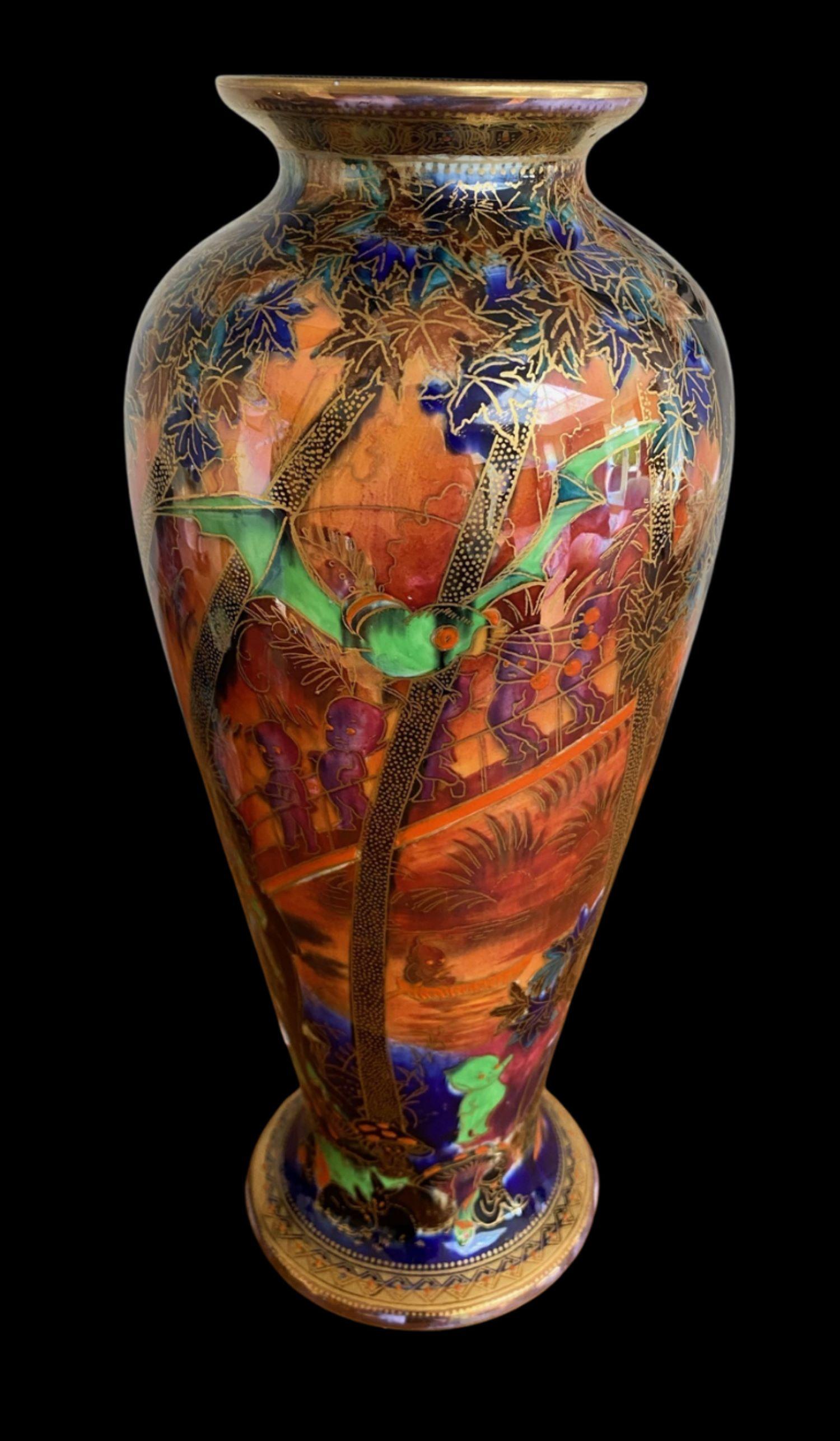 5158

Wedgwood Fairyland Lustre Vase by Daisy Makeig Jones decorated with “Imps on a Bridge” design in the Flame colourway

Circa 1920

Measures: 26.5cm high.