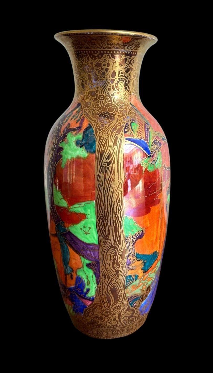 5391
Daisy Makeig Jones
A Wedgwood Fairyland Lustre Vase decorated in the “Ship and Tree” design in a Flame Colourway
20.5cm high, 8.5cm wide
circa 1920.