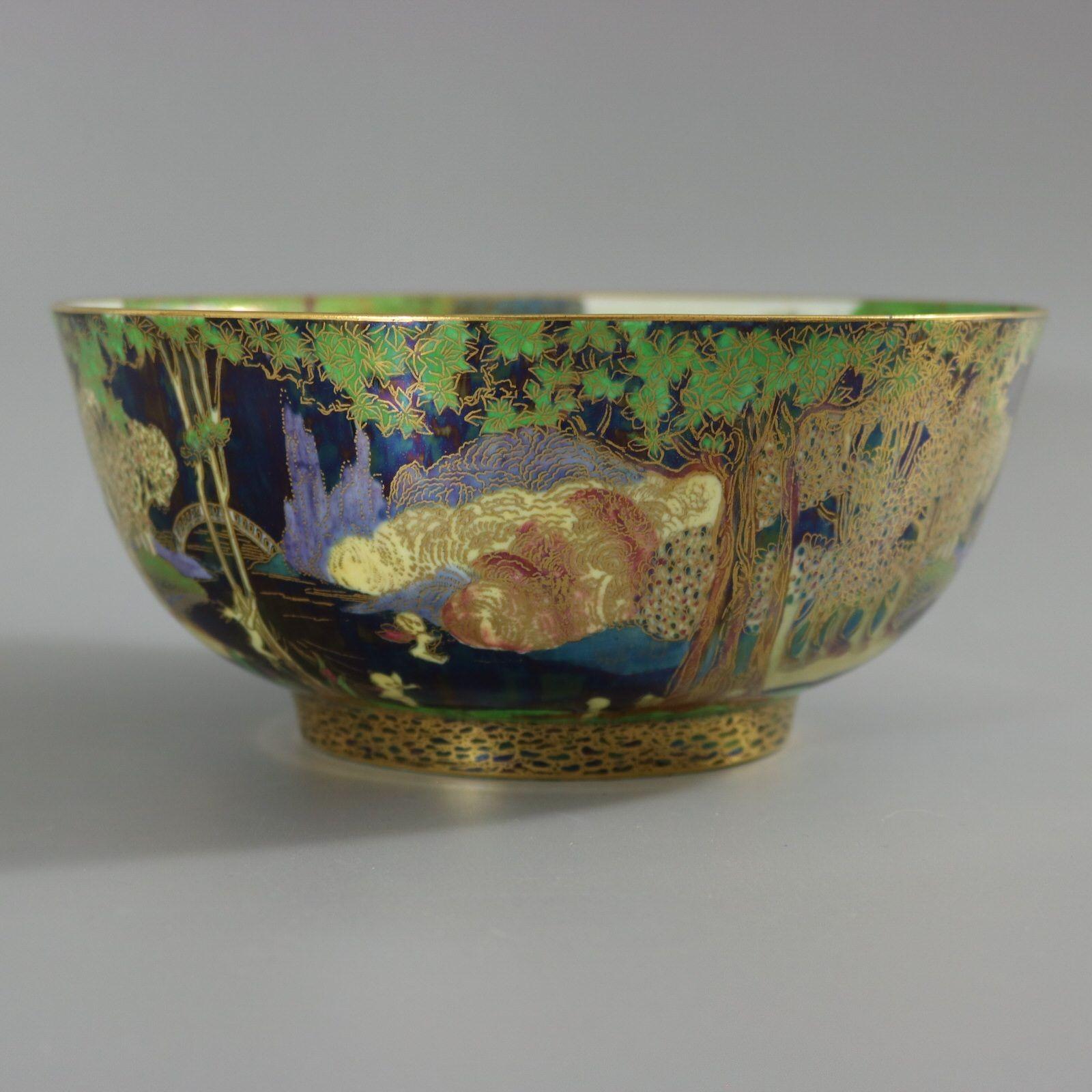 Wedgwood Fairyland lustre imperial bowl. Exterior decorated with the Woodland Bridge pattern on black background. Cobble bead around the foot. Interior is decorated with the Picnic by a River pattern. Pattern number 'Z4968' and gilt Portland Vase