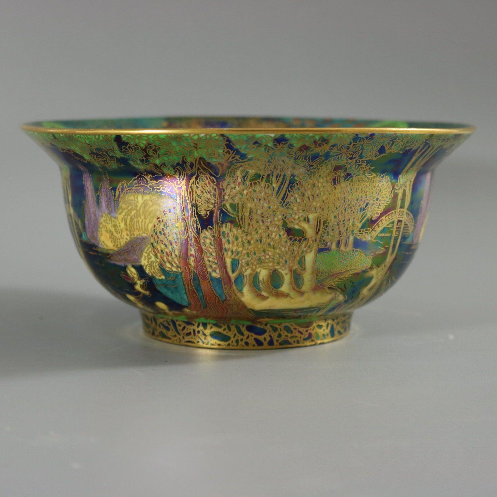 Wedgwood Fairyland lustre K'ang Hsi bowl. The exterior decorated in the 'Woodland Bridge Variation 1' design on black ground. The interior with a variation of the 'Garden in Paradise' design. Cobble bead border to the foot rim. Portland Vase back