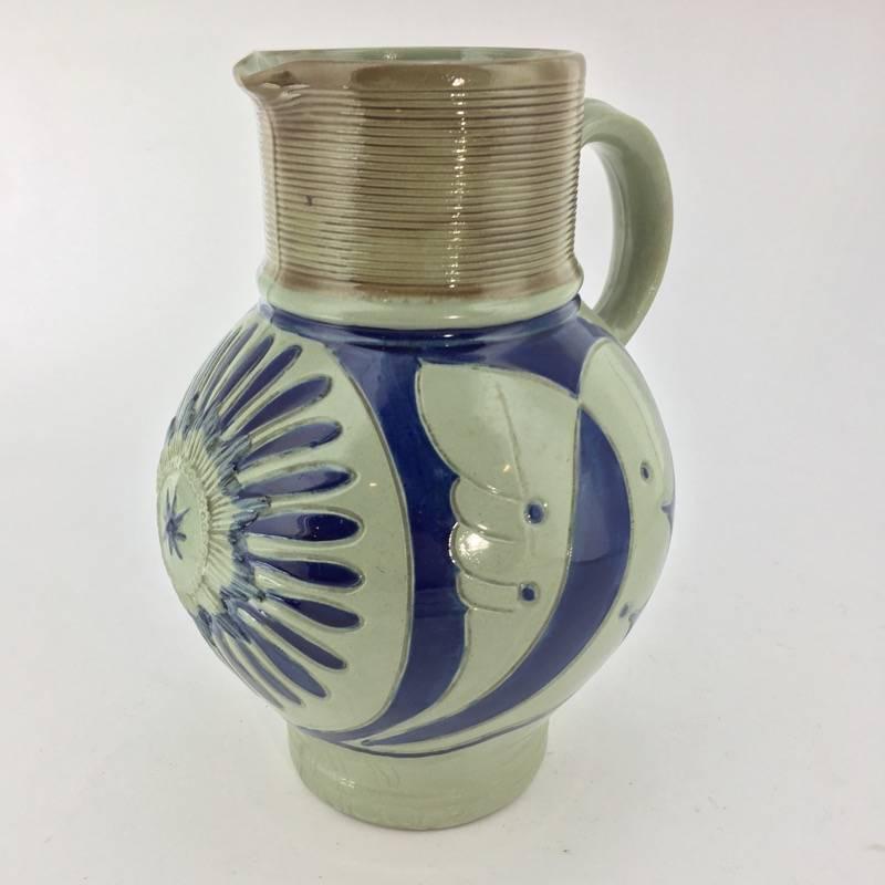 Unusual Wedgwood jug in blue toned body, modelled after a 17th century German saltglaze type, with incised leaf decoration framing a central applied medallion, the grooved rim and lip with a brown wash. Impressed ‘WEDGWOOD’, also ‘S’ and ‘MDY’19th