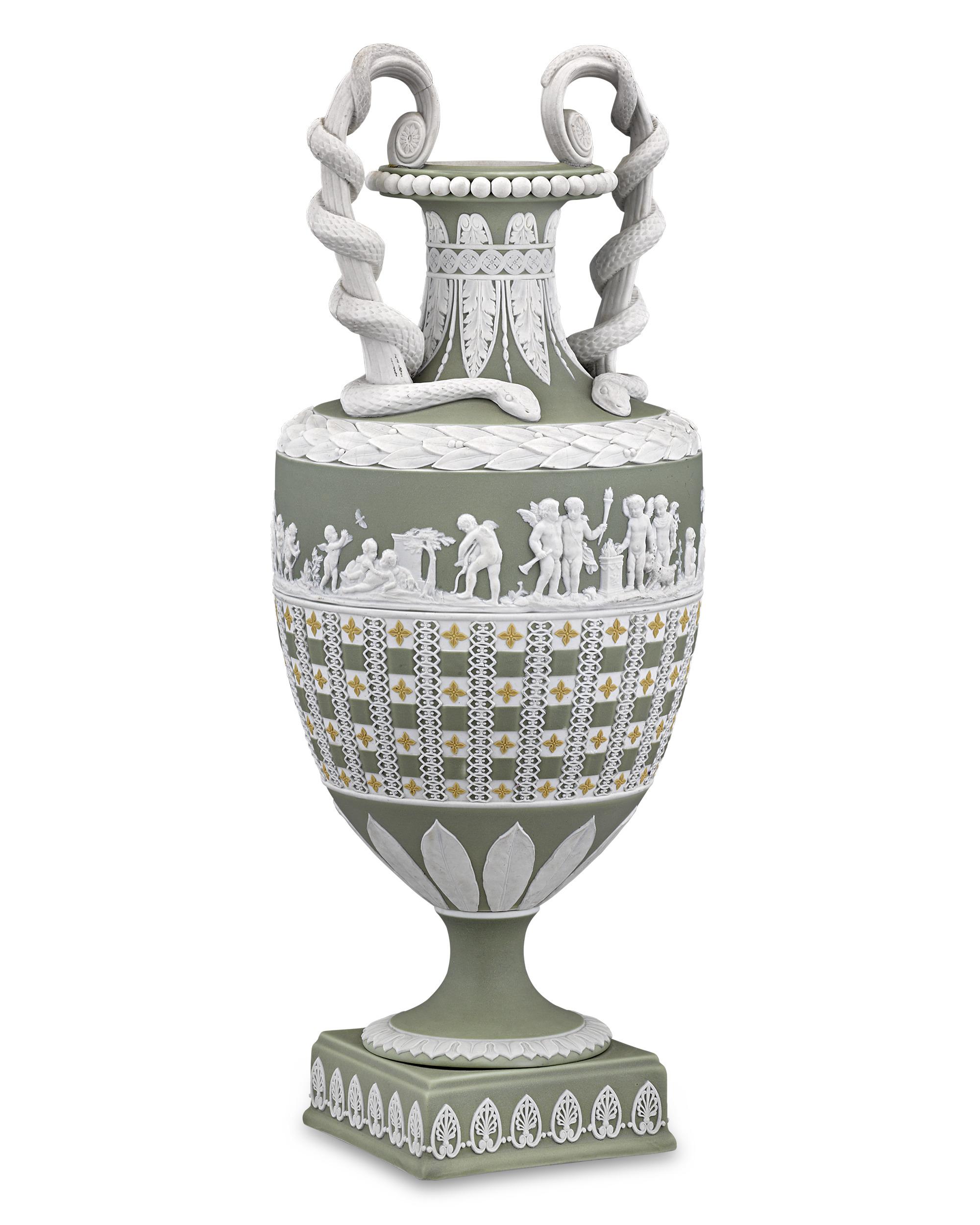 Tricolor jasperware was one of Wedgwood’s most celebrated innovations, and this exquisitely rare vase is an extraordinary example of this wondrous technique. The tall neck of the graceful amphora form is flanked by upright scroll handles entwined