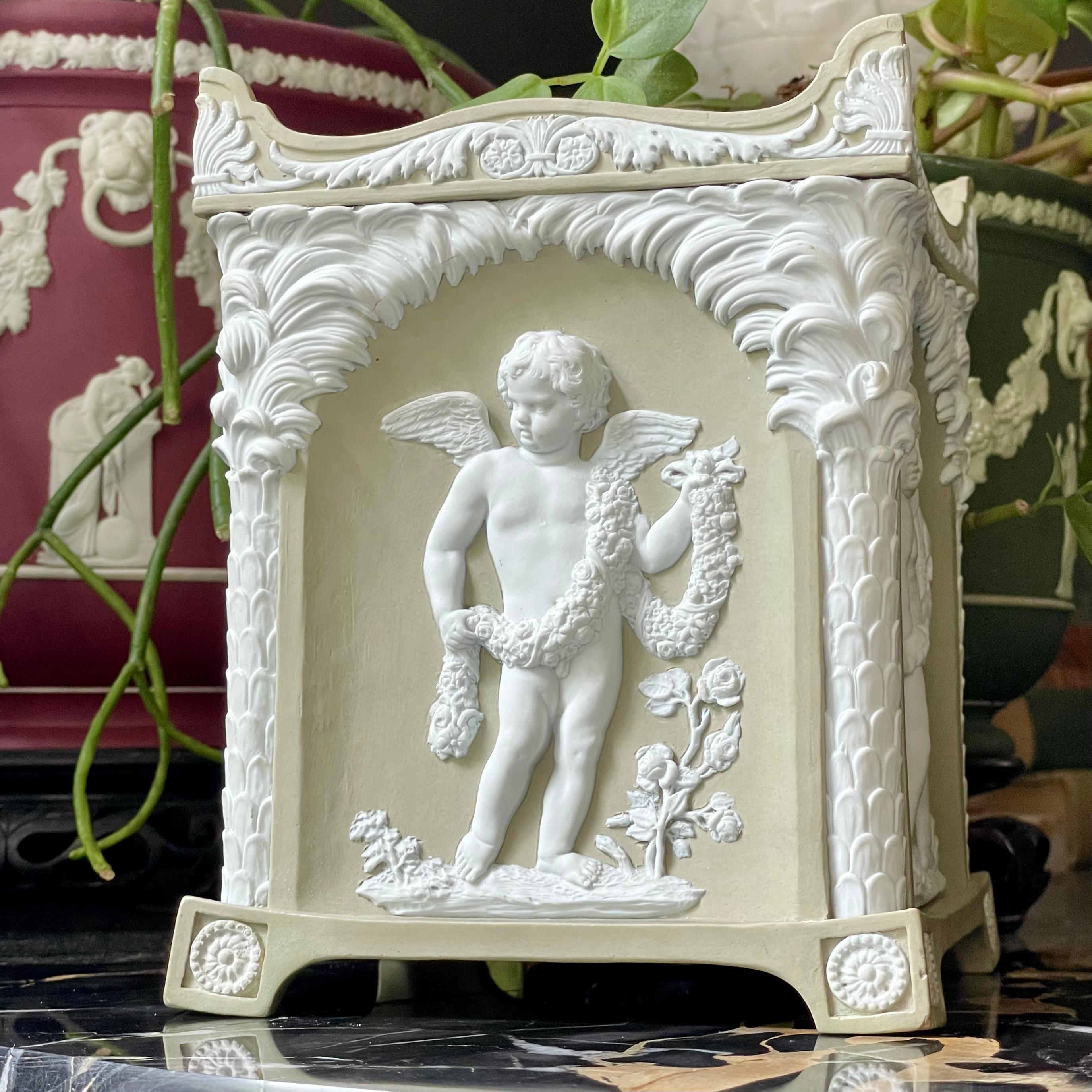 Etruria, Staffordshire, circa 1785, chalky solid buff-green jasper ware rectangular molded body, applied and finely undercut white jasper bas- and haut-relief decoration depicting cupid as each of the four seasons under a palm arcade, scalloped