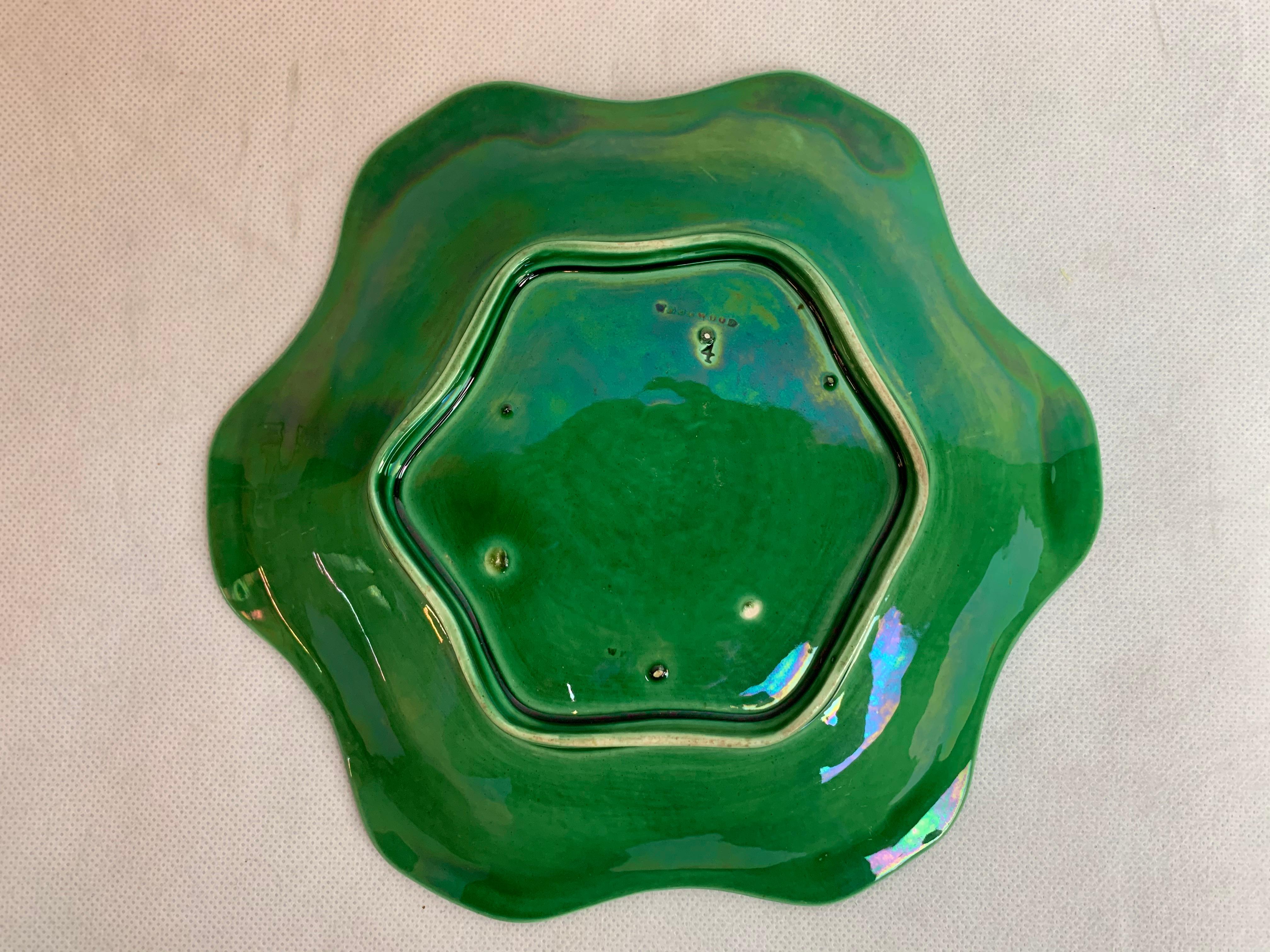 Unusual six lobbed Wedgwood green majolica plate. The design is of six green leaves on a basket weave ground. Attractive on a table or hung on a wall.  Marked Wedgwood on the reverse.

Diameter-8.5