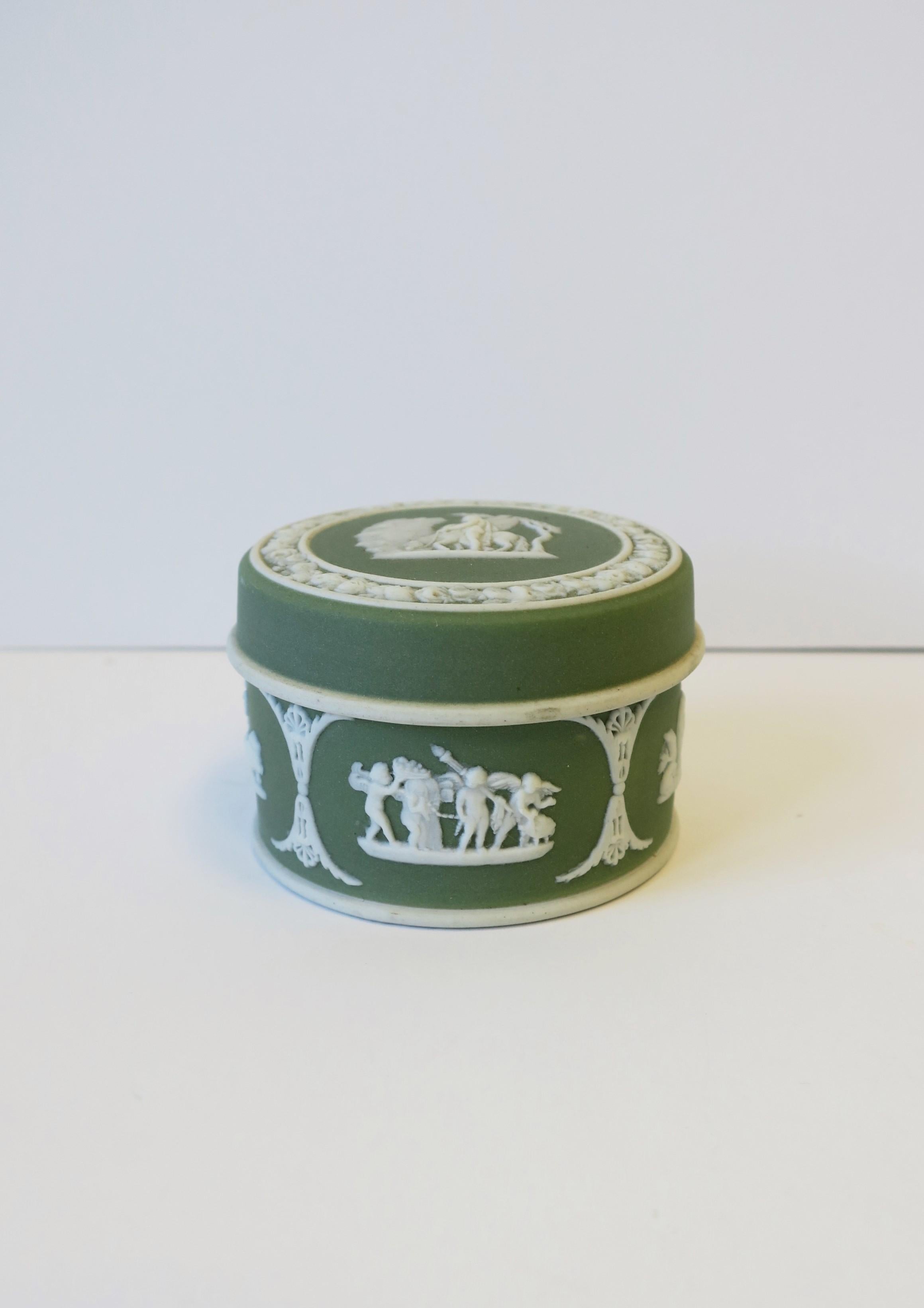 A beautiful English green and white Wedgwood Jasperware round box in the Neoclassical style, circa late-19th century, England. Lid features detailed raised relief with equine horse with wings and male rider. Other beautiful Neoclassical raised