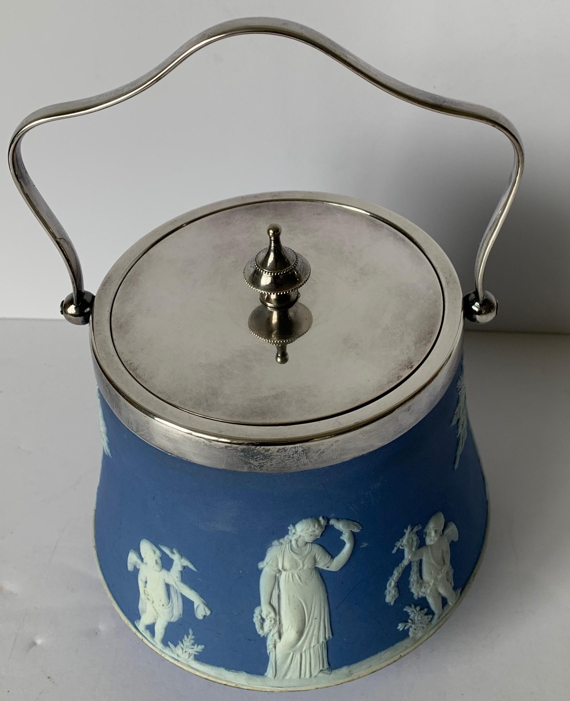 Wedgwood light blue bell shaped jasperware biscuit barrel overall neoclassical motif with a silver plated lid and handle. Stamped Wedgwood on the underside and lid is marked.