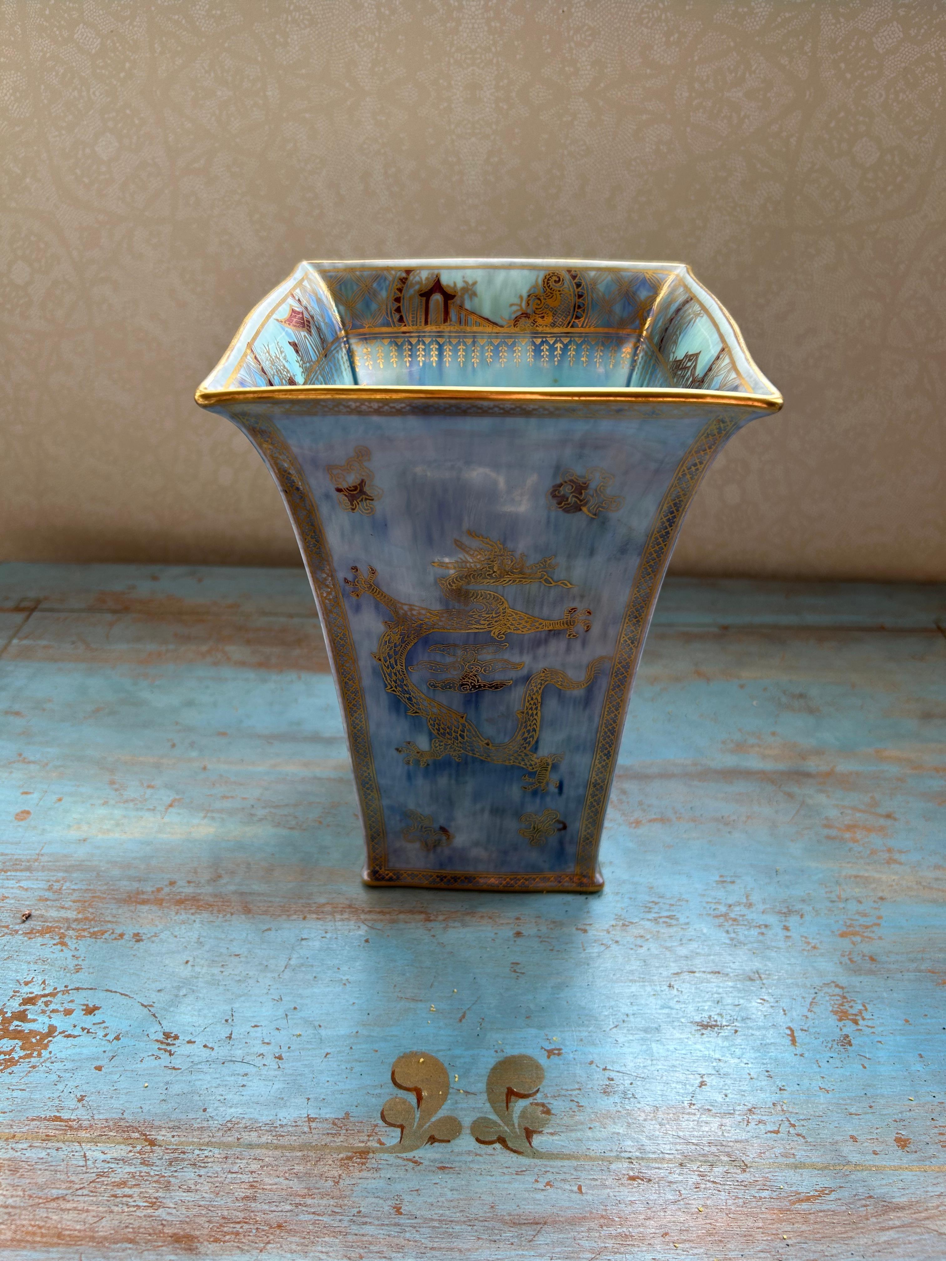 Si tratta di uno splendido vaso a lustro di Wedgwood, del 1914 circa, disegnato da Daisy Makeig-Jones. Il vaso dalla forma svasata ha una sovraverniciatura iridescente su un fondo blu pallido ed è decorato con draghi vorticosi e dettagliati in oro