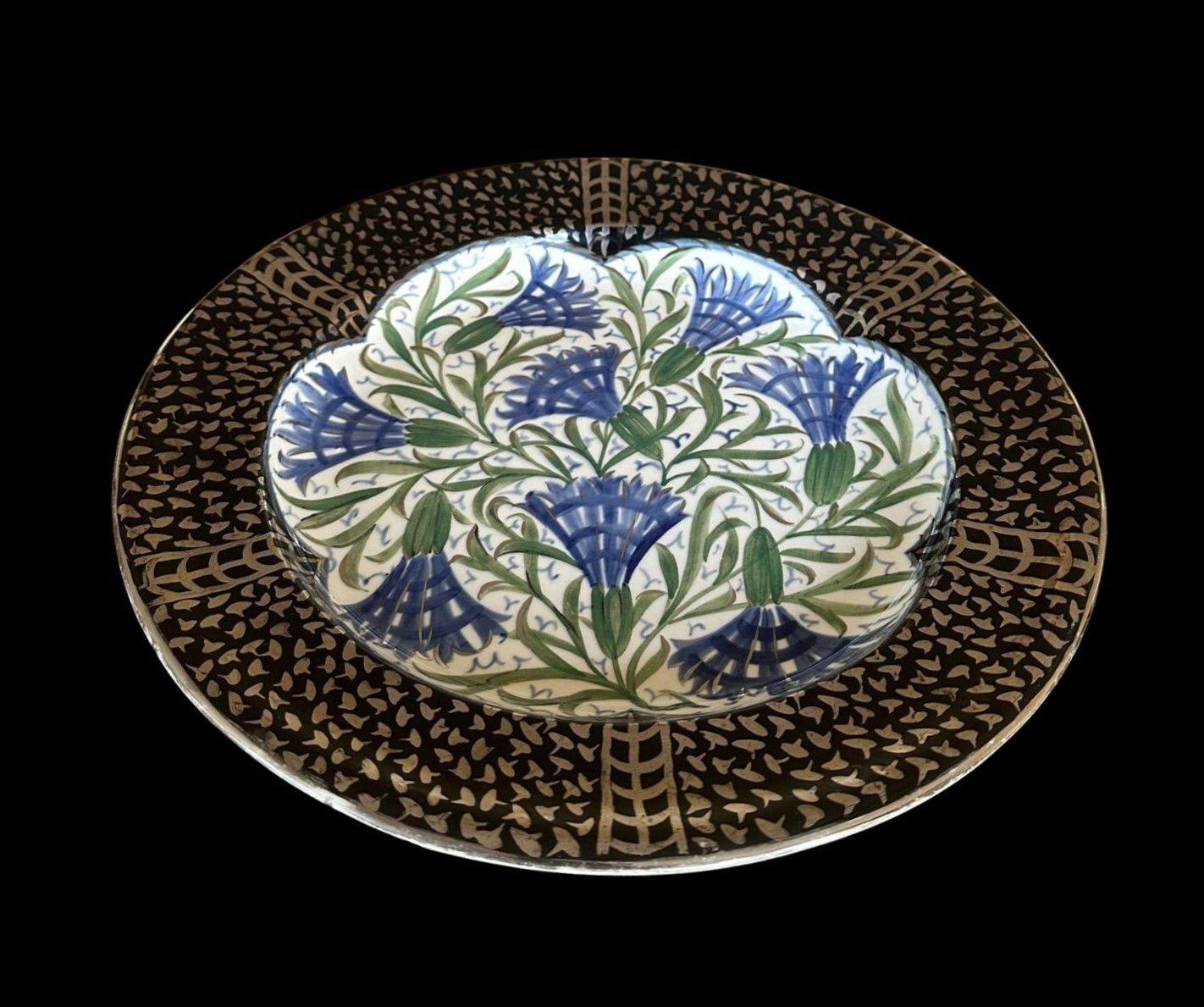 5366
Louise Powell for Wedgwood.
A lustre Plaque in the Persian Palate, decorated with stylised carnations with silver lustre and a black border with silver highlights
32cm wide, 3cm deep
Circa 1920