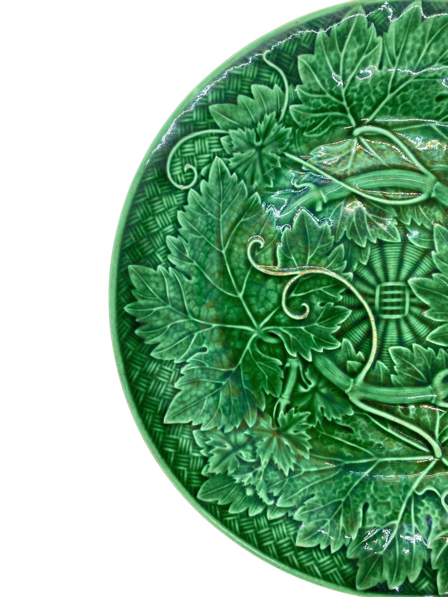 Wedgwood Majolica green glazed plate, with relief-molded grape leaves and vines, raised on a basketweave ground, the reverse with impressed mark 'WEDGWOOD.'

For 30 years we have been among the world's preeminent specialists in the finest antique