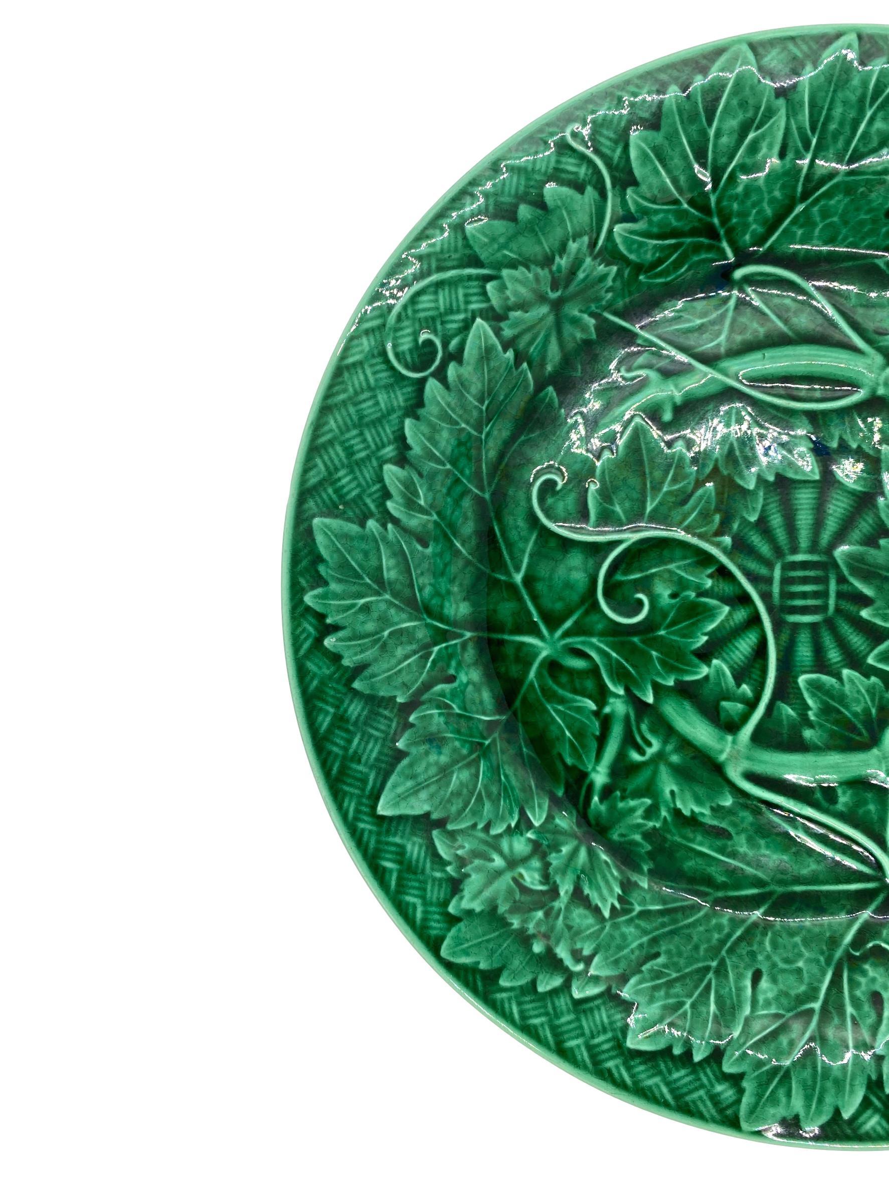 Wedgwood Majolica Green Glazed Plate, with relief-molded grape leaves and vines, raised on a basketweave ground, the reverse with impressed mark 'WEDGWOOD.'

For 30 years we have been among the world's preeminent specialists in the finest antique