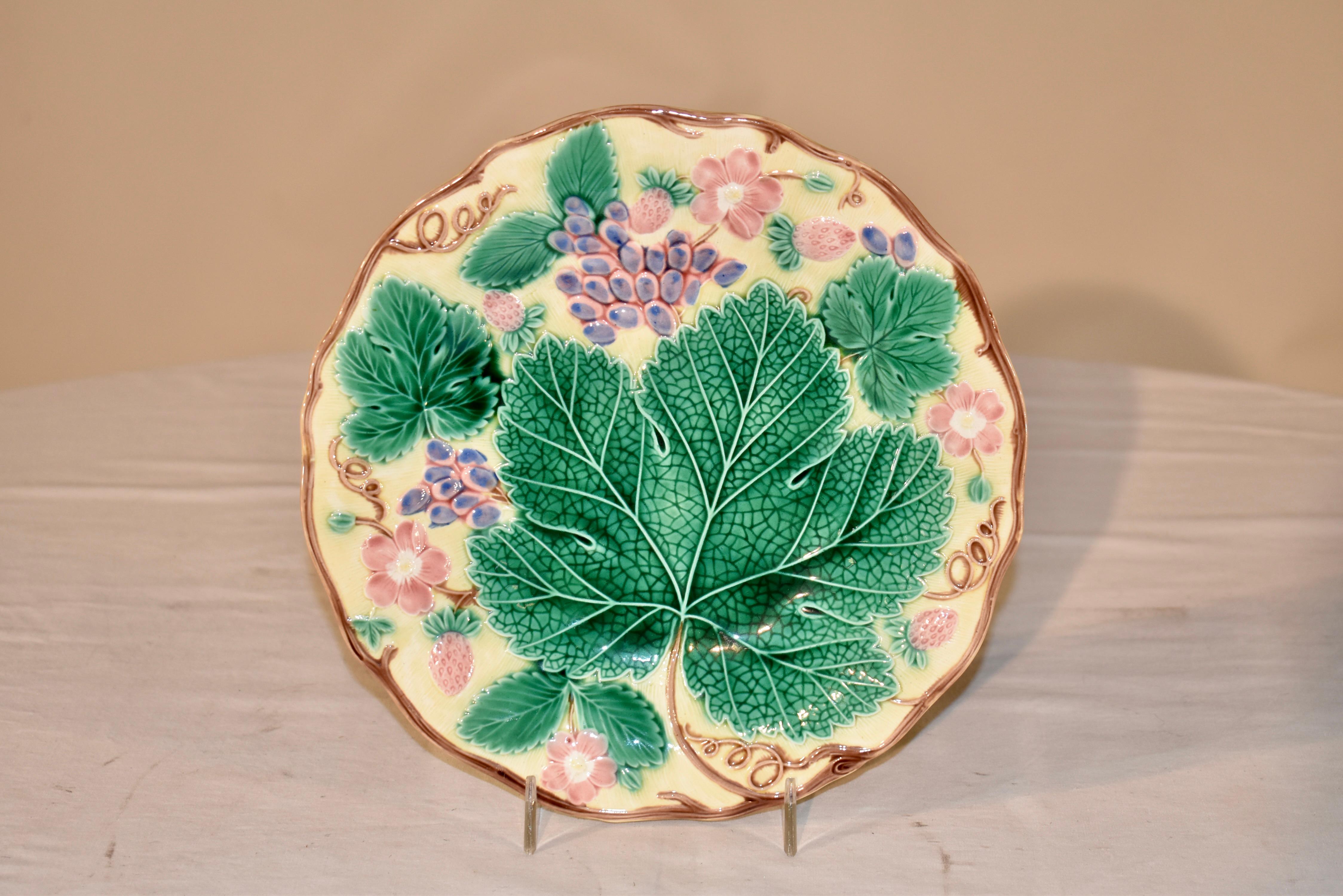 Wedgwood majolica leaf plate in a gorgeous pale yellow color background. The border is molded in a vine design, surrounding a central large grape leaf and decorated with grapes, florals and strawberries. This is a lovely pattern I have had in solid
