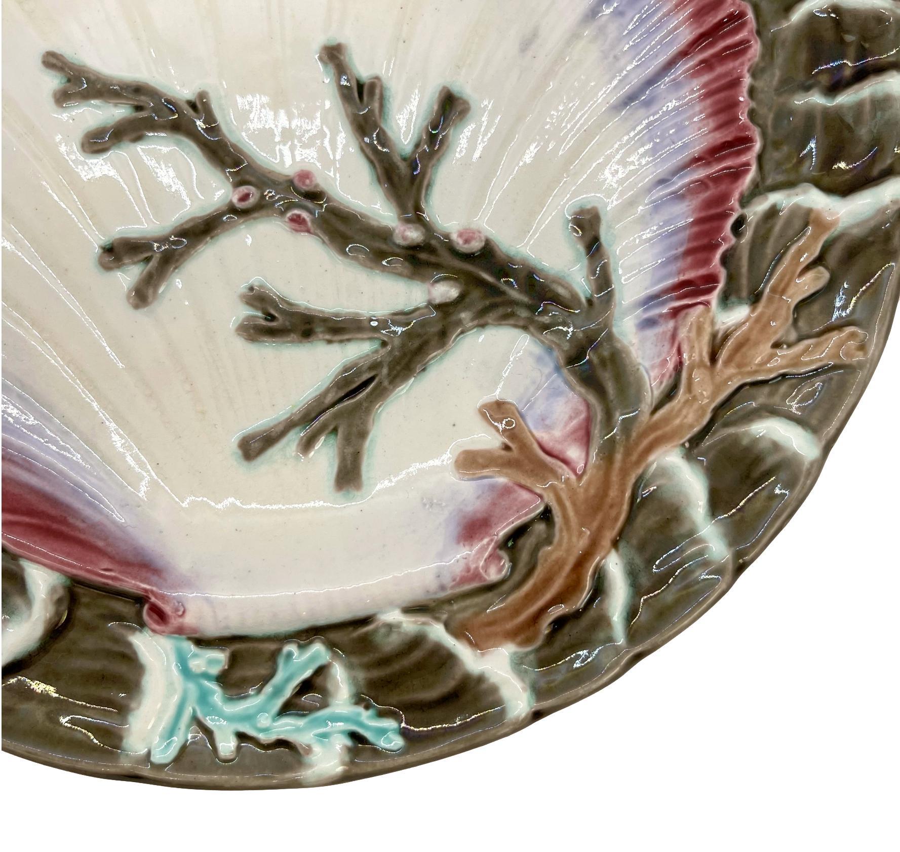 Wedgwood Majolica Ocean plate, with a large central shell and seaweed, bordered with relief-molded waves, the reverse with impressed marks: 'Wedgwood,' and Wedgwood date letter, 'F' for 1877, with underglaze painted design number, '2934,' which